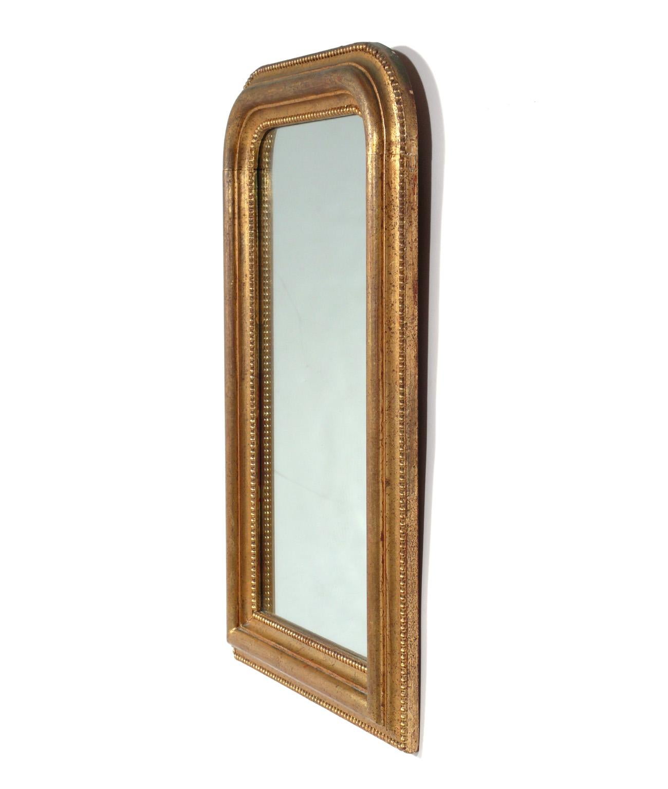 Arched gilt mirror, Italy, circa 1950s. Retains warm original patina to both the original mirror and gilt wood frame. It is a petite size, measuring 31