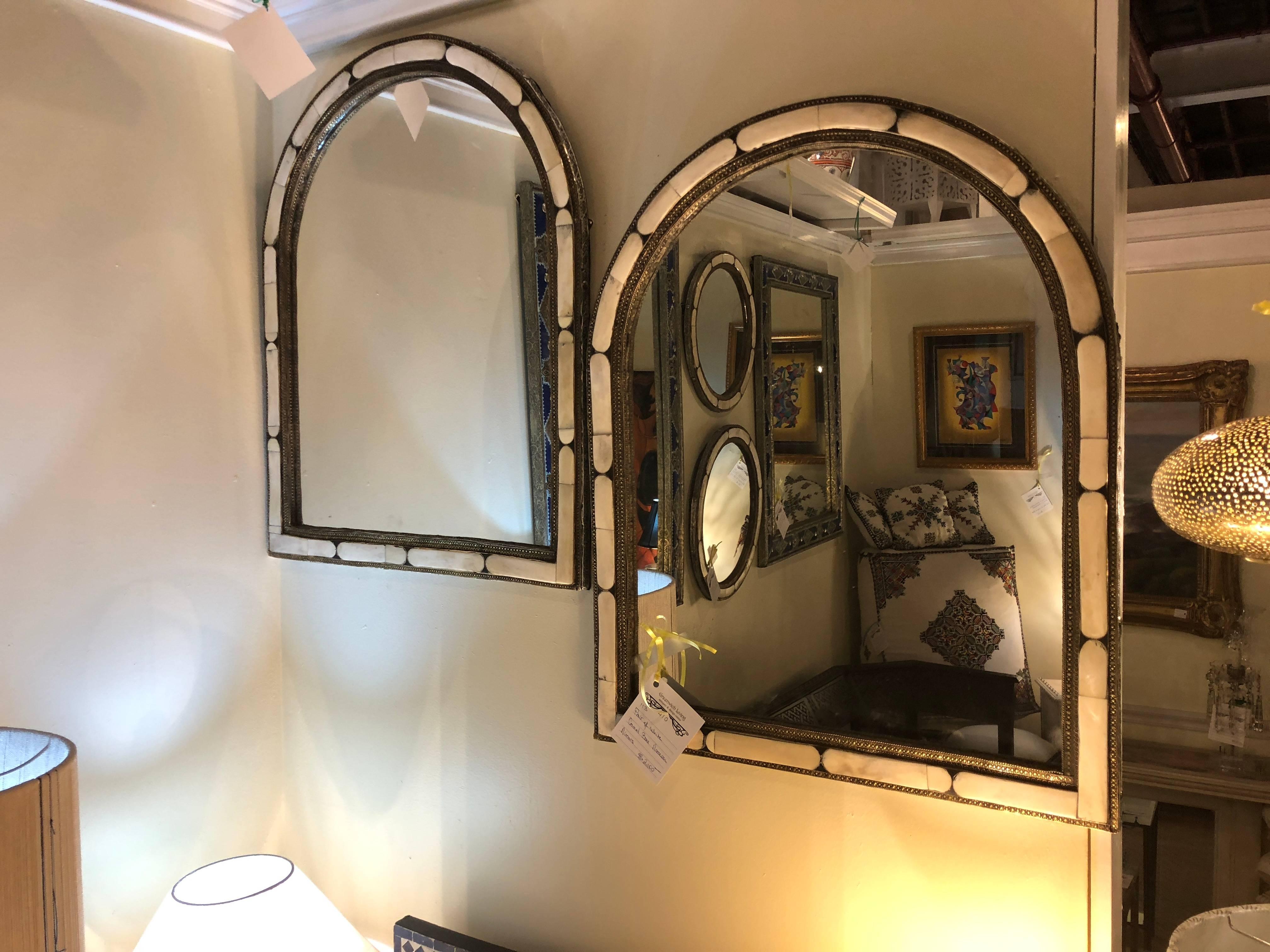 Arched Hollywood Regency white camel bone mirror, a pair
A pair of arched white camel bone mirrors. With white camel bones inlaid into an elegant brass frame, this pair of handmade Hollywood Regency mirrors will complement any room and interior