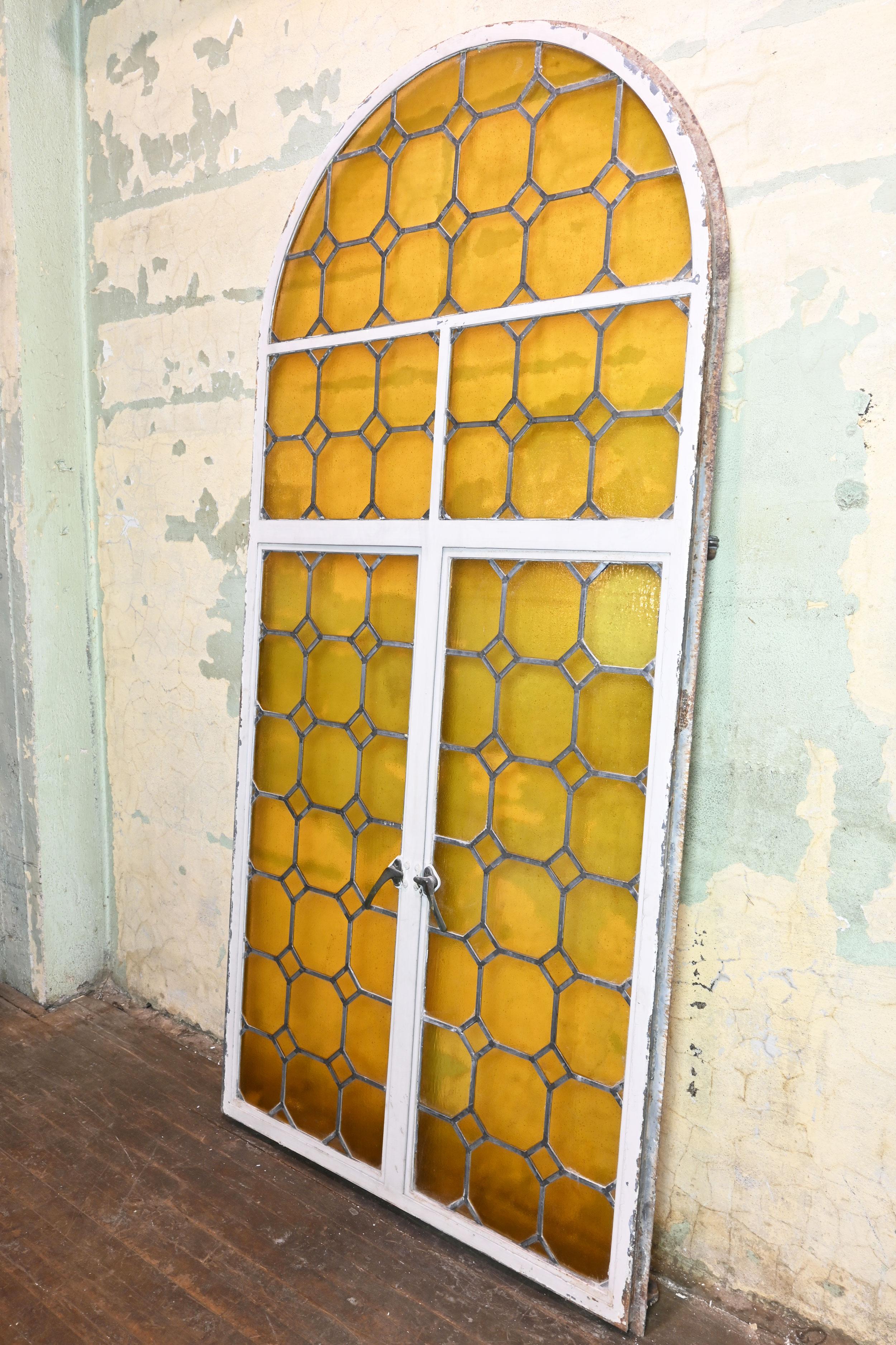 North American Arched Iron Framed French Window with Yellow Glass For Sale