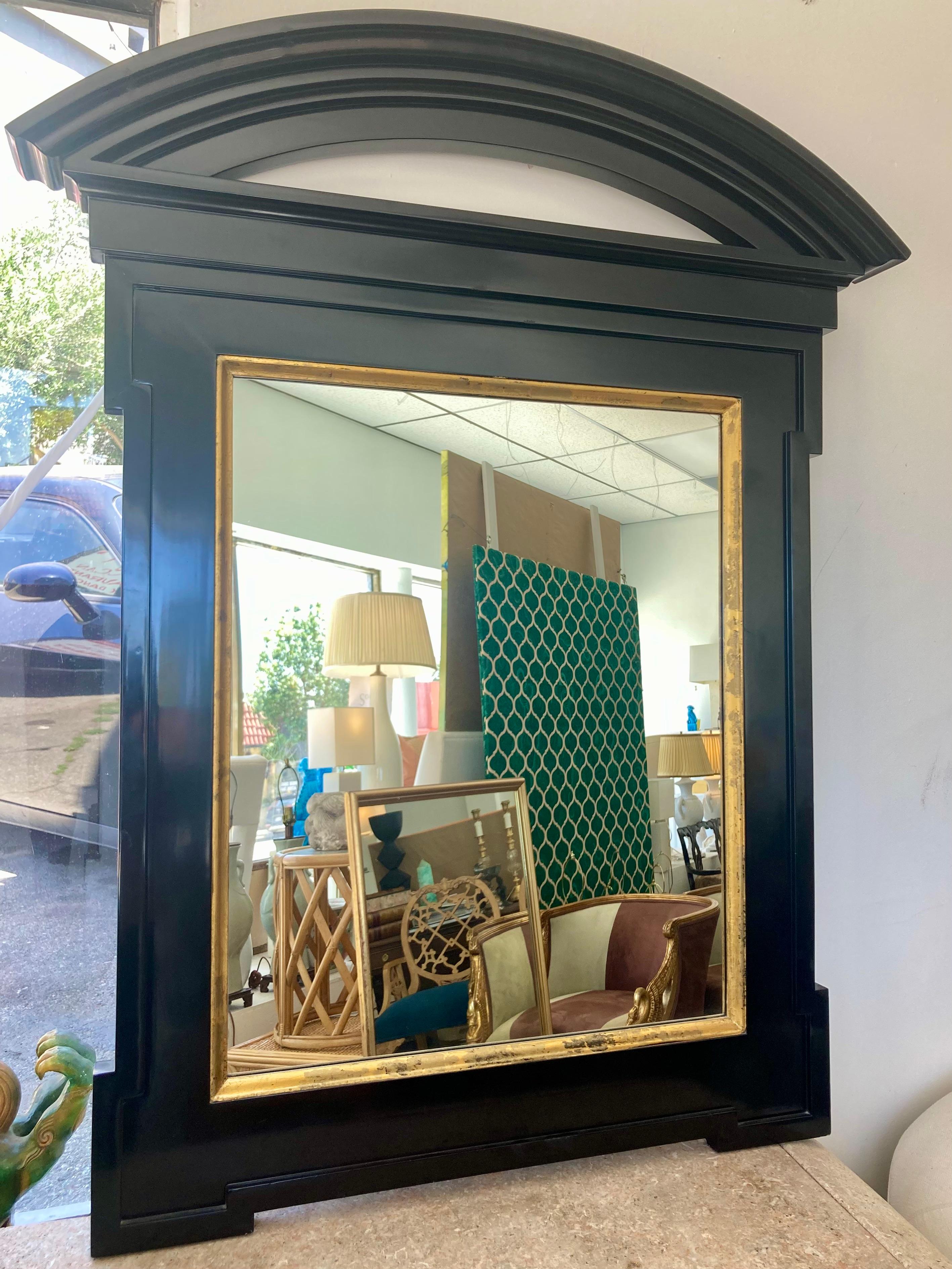 Arched pediment mirror by John Hutton for Donghia in a custom size and black gloss finish with gilt details. Gorgeous color combination with black and gold. Add some chic architecture and drama to your interiors or design project. Very rare arched