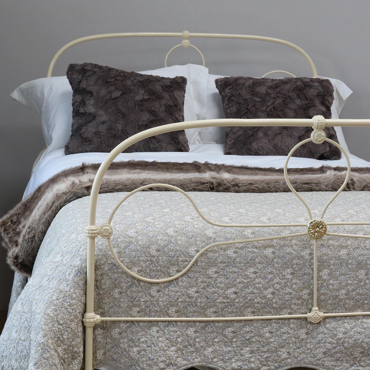 Cream antique bed with simple arched design and central brass rosette.

This bed accepts a small double size (4ft wide, 48 inches or 120cm) base and mattress set.

The price includes a standard firm bed base to support the mattress. 

The mattress,