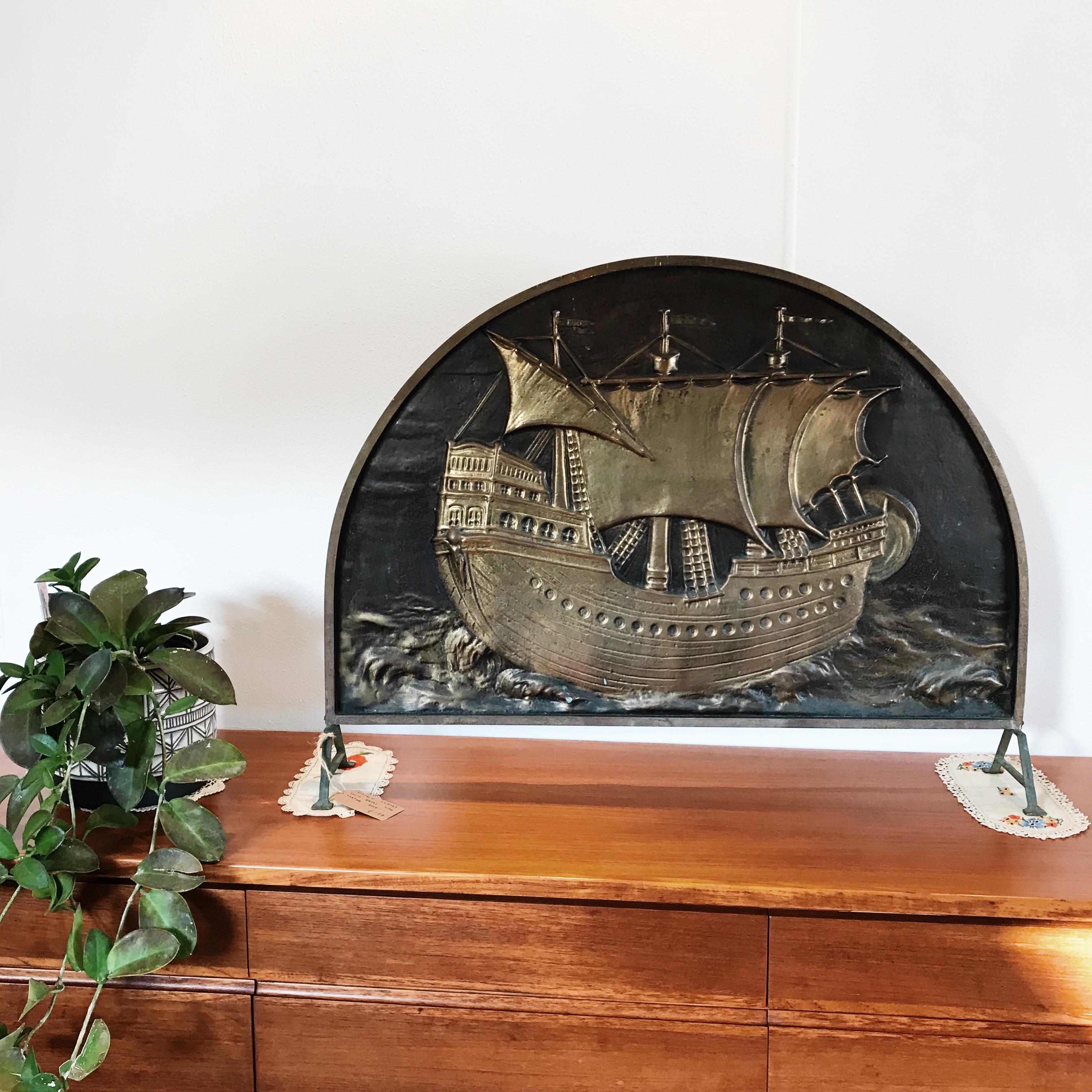 Absolutely stunning solid brass, Art Deco, fire keeper by Myttons Limited, Australia. 

The solid brass, hard line framed screen depicts a sailing galleon, which has been masterfully hand-hammered and has a patina which is both bold and