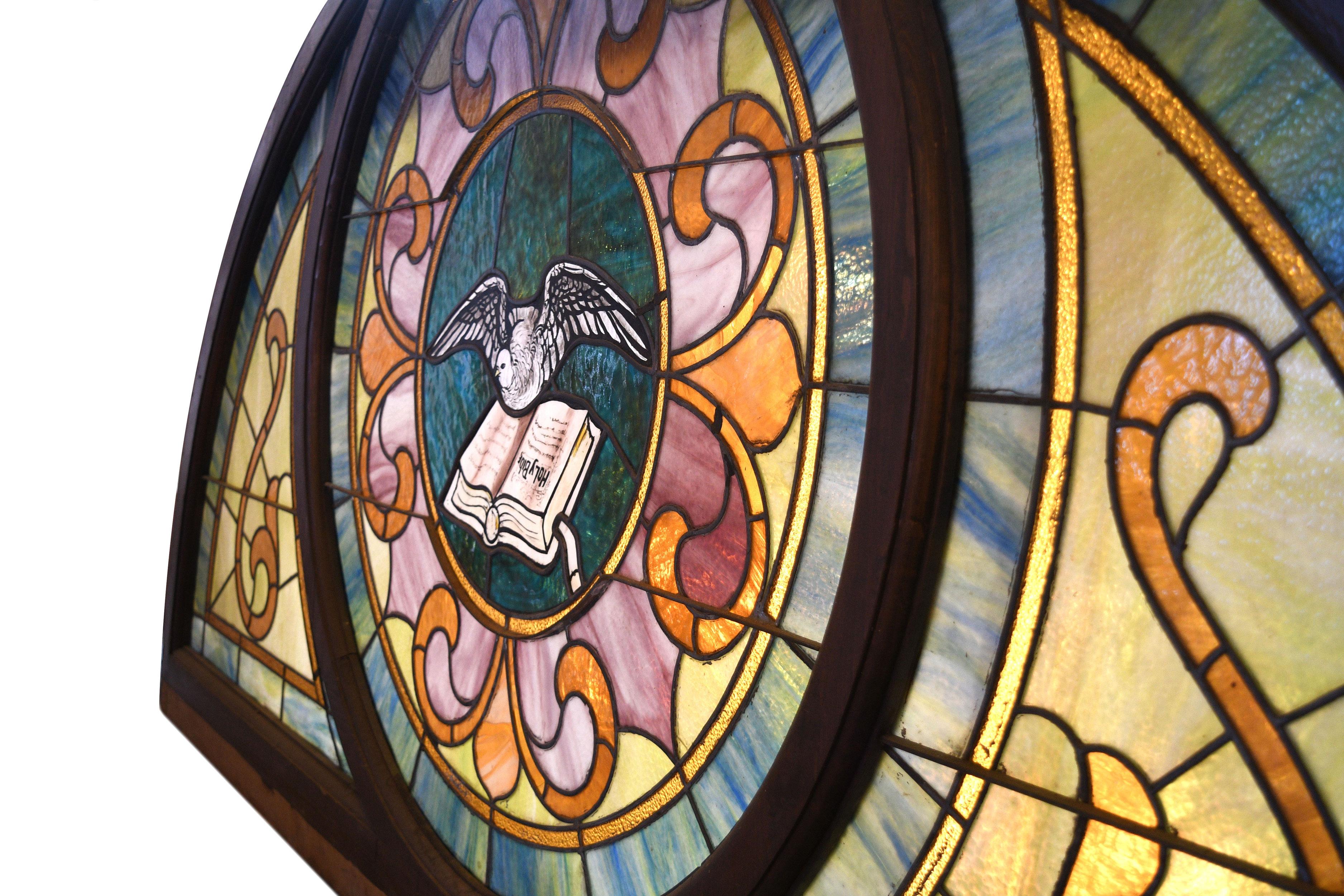 Beautiful pastel colored slag and stained glass window. The green/blue, orange/yellow and pinks all come together to make a soft and peaceful image. The dove and Bible motif at the center is hand painted. It comes together as a whole through organic