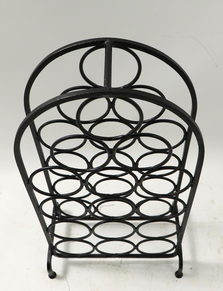 Nice counter top scale wrought iron wine rack holds up to 15 bottles. Well constructed of heavy gage material, design after Arthur Umanoff.