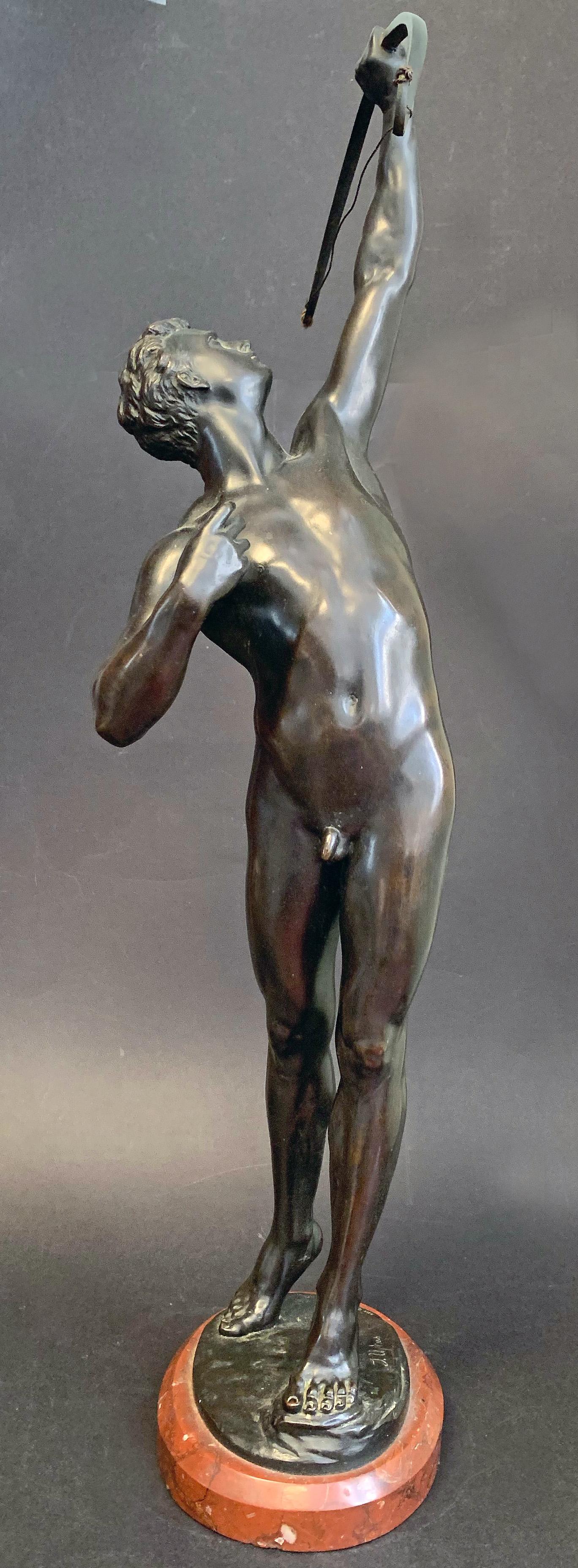 In our opinion, one of the greatest depictions of the male nude in 19th century sculpture, this large bronze by Joseph Uphues depicts a youthful male archer shooting his arrow upwards, no doubt toward a bird overhead. The figure is full of energy