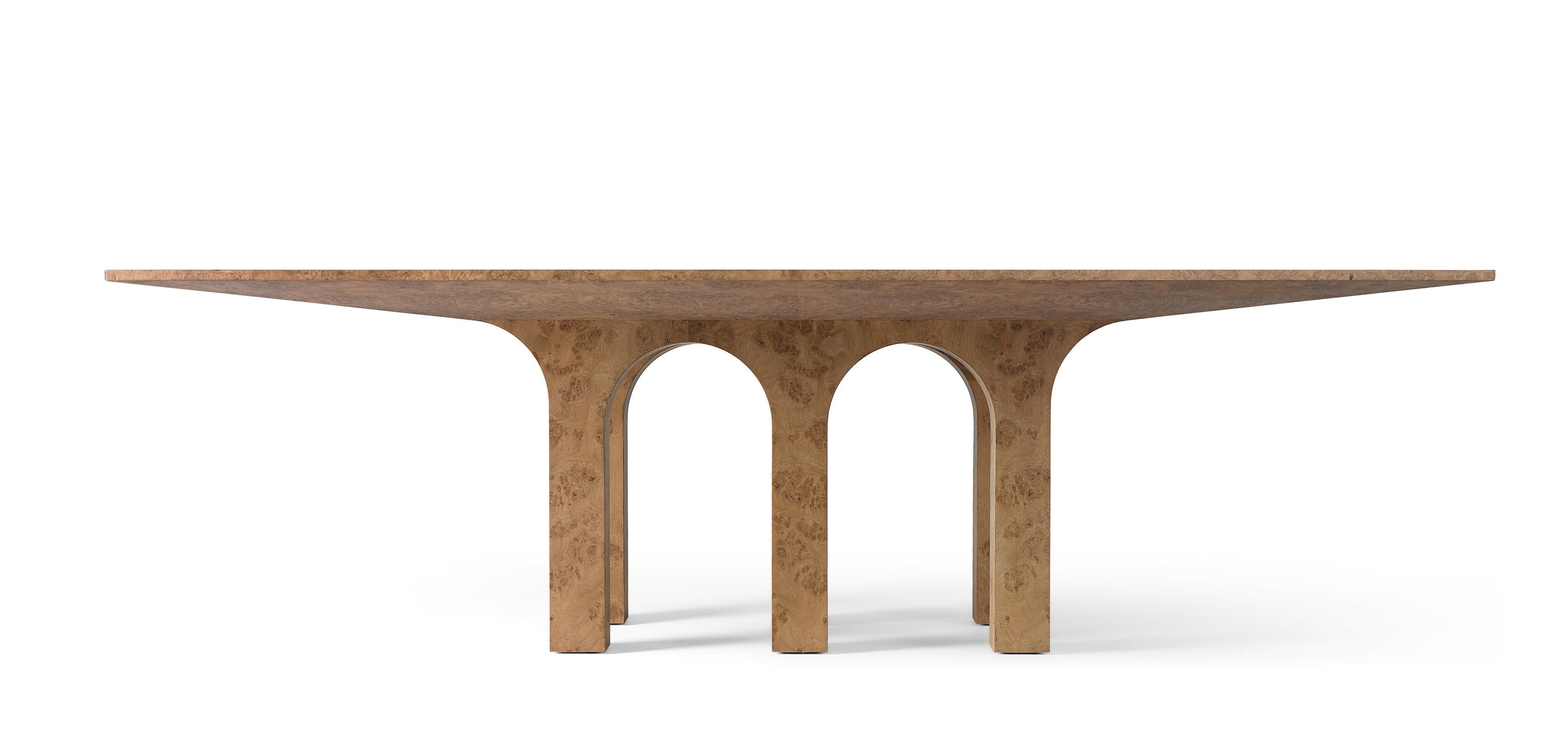 This table is a monumental piece covered entirely in inlaid oak root, born from the fusion of classic architectural forms of arches and cross vaults and the tradition of noble cabinetmaking workmanship.
The base is composed of six legs that draw a