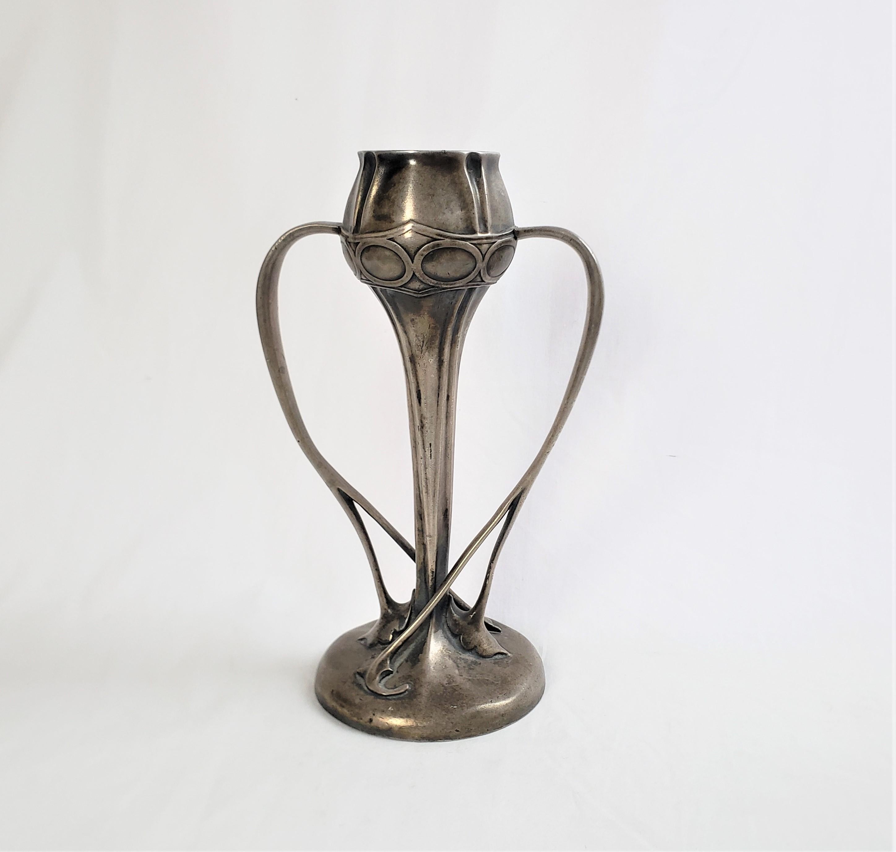 This vase is unsigned, but being attributed to the well known artist Archibald Knox of Scotland and dates to approximately 1910 and done in his signature Art Nouveau style. The vase is composed of pewter and is done in a naturalistic form with