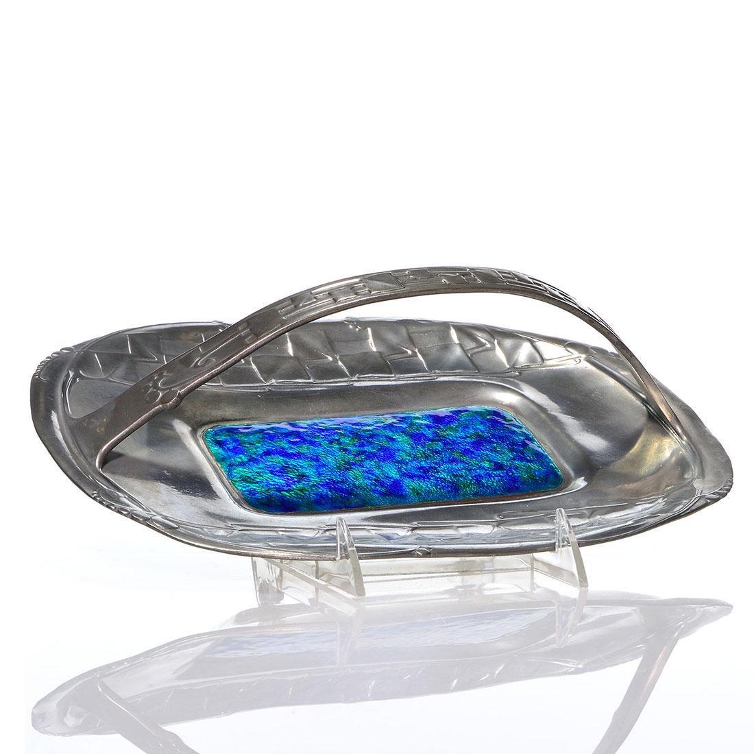 An antique English pewter tray of oval form with a loop handle and bright field of blue and green enamel by Archibald Knox (1864-1933) for Liberty & Co. of London, circa 1902-1905. Knox is best known for his Tudric pewter and Cymric silver designs