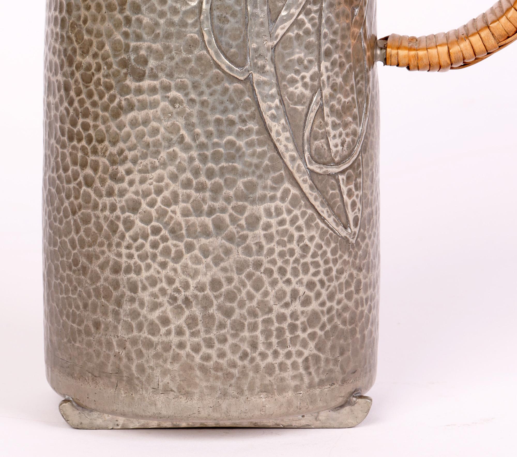 A stylish art nouveau Tudric pewter jug or coffee pot molded with stylized mushroom designs by renowned designer Archibald Knox (British, 1864-1933) and dating from around 1904. 

Many of these pieces were made and retailed through Liberty & Co,