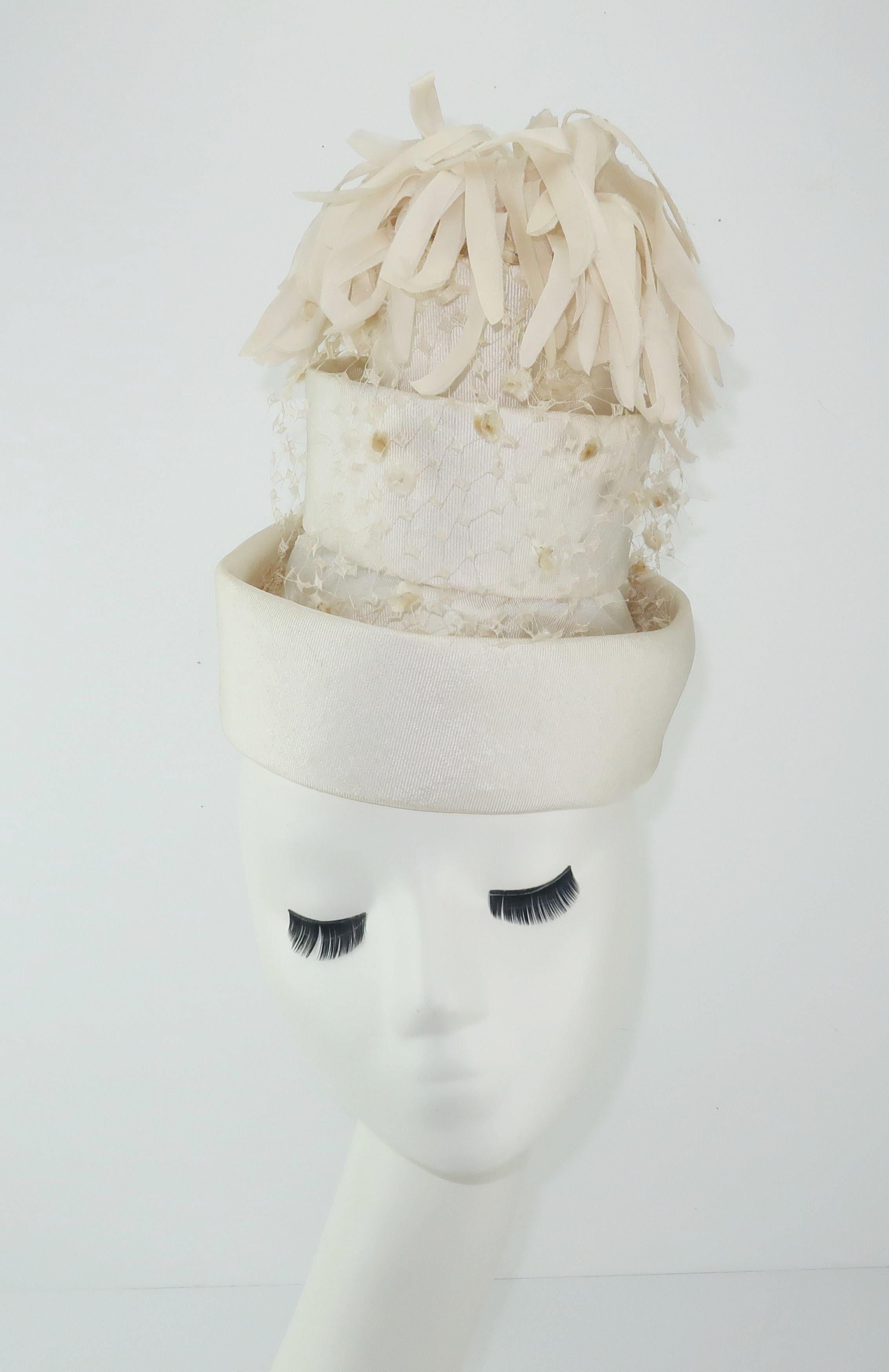 Turn heads and wow a crowd with this C.1960 Archie Eason candlelight white faille fabric hat constructed with layers resembling a wedding cake.  Originally from Georgia, Mr. Eason started his career as a milliner in the 1950’s creating unusual and