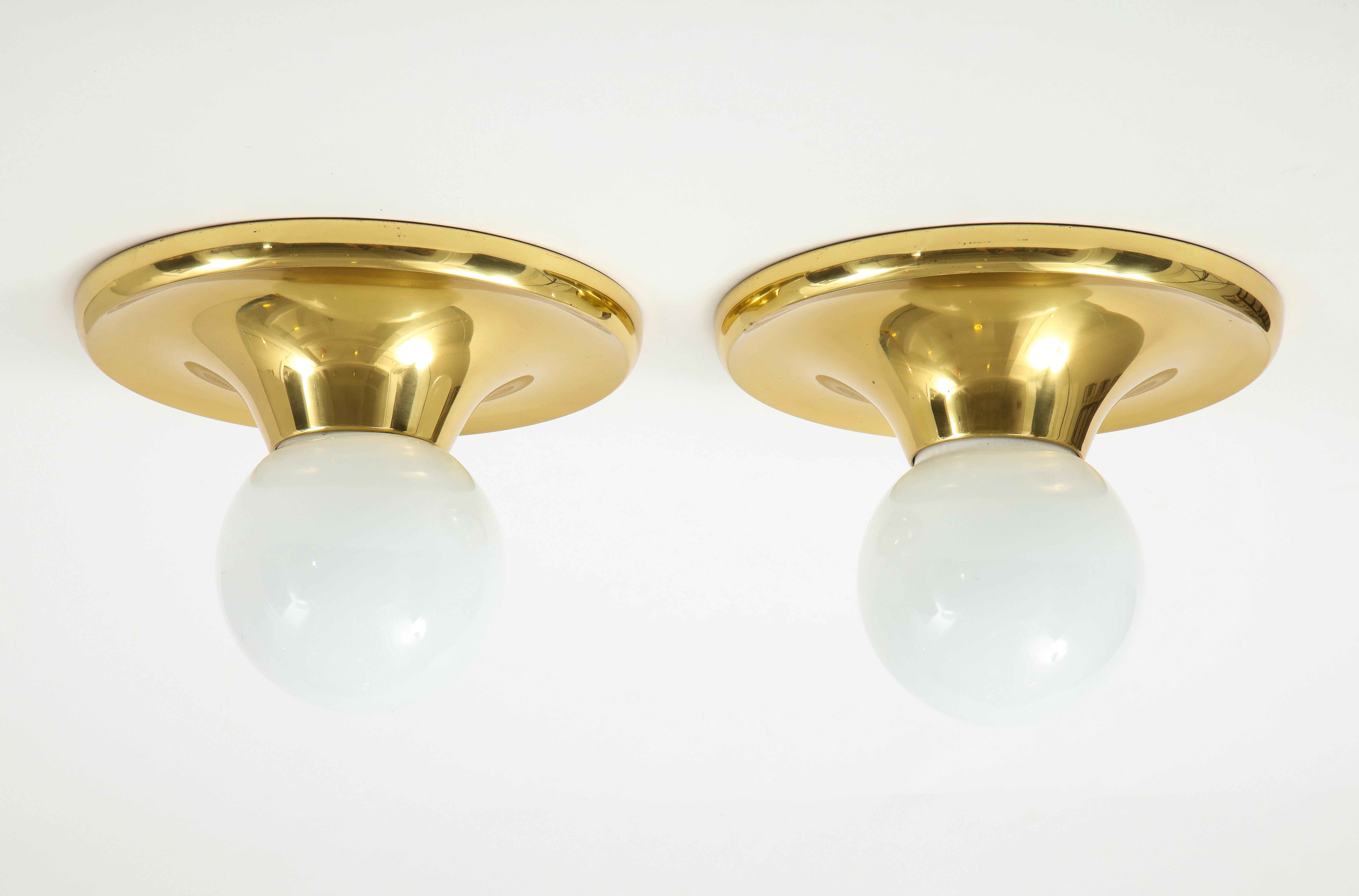 Stunning pair of 1970s large brass sconces designed by Archille Castiglioni for Arteluce. In vintage original condition with minor wear and patina.