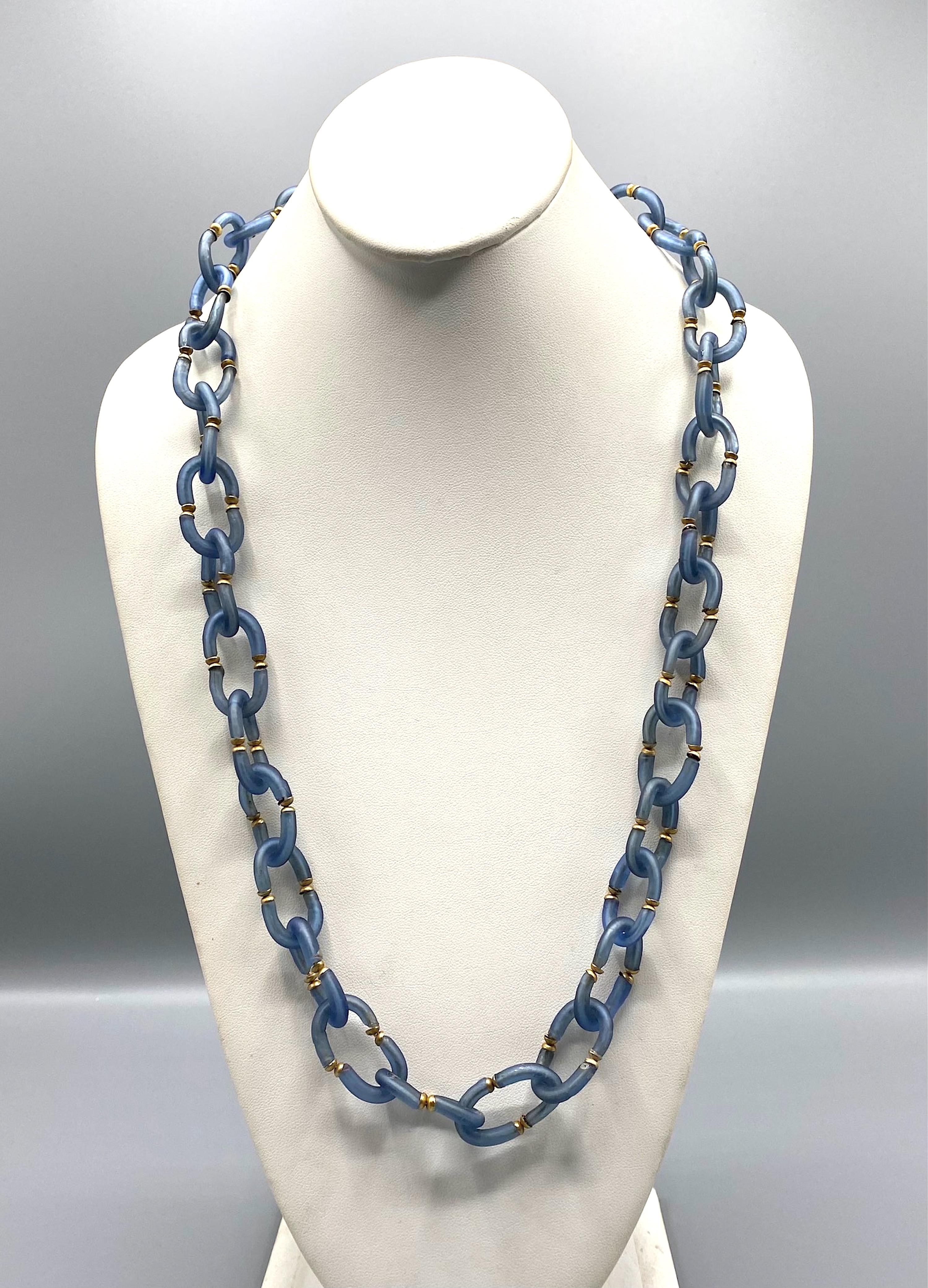 Lovely glass chain necklace by Archimede Seguso of Italy. Chain links are hand formed of two C shape glass pieces. The necklace is 29 inches long and .75 of an inch wide.
Unusual round Clasp with beads and glass small bars
