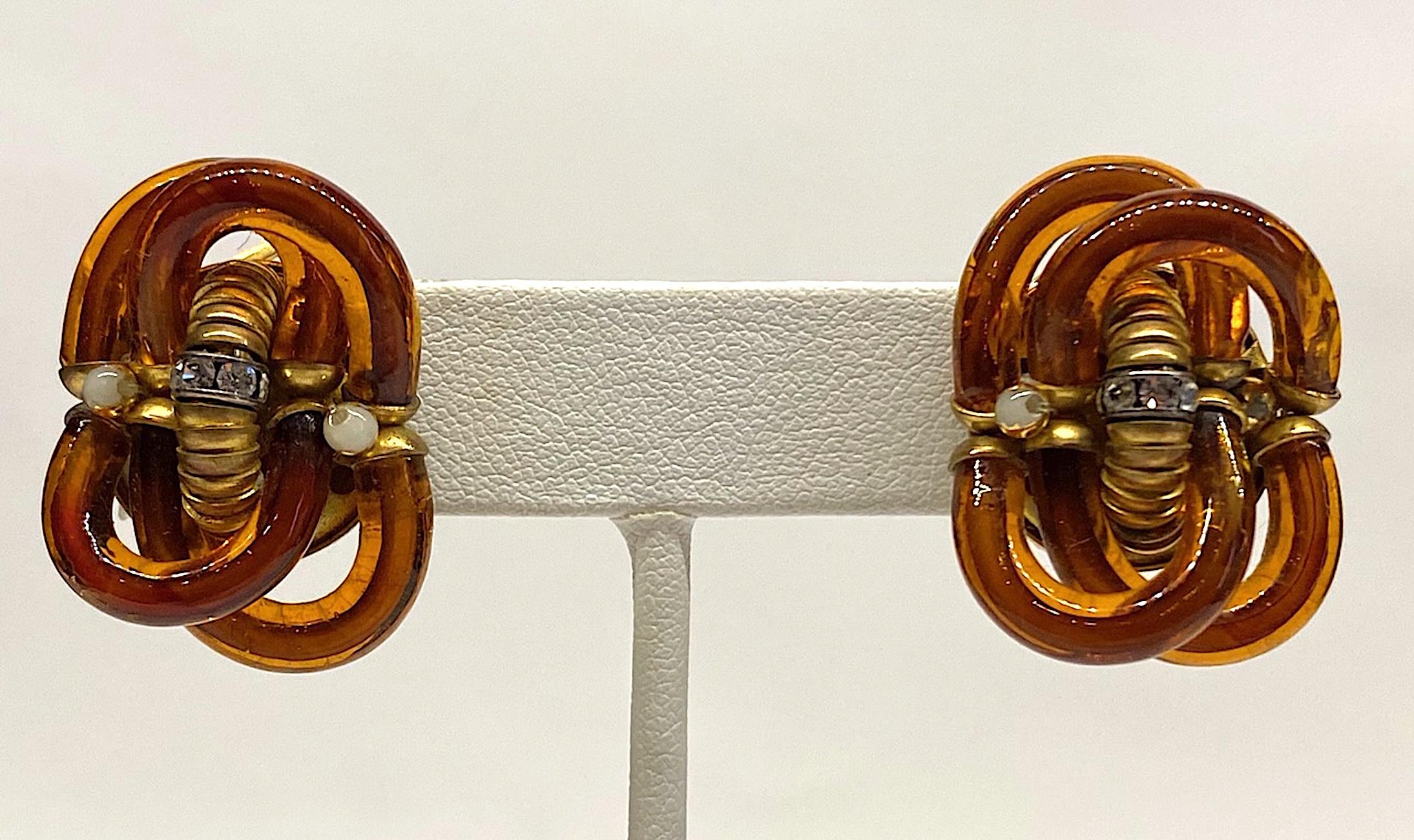 A wonderful pair of hand blown amber glass tube link earrings by famous Italian glass designer Archimede Seguso circa 1960. Each earring measures approximately .88 of an inch wide, 1.13 inches tall and .63 of an inch deep including the clip. The
