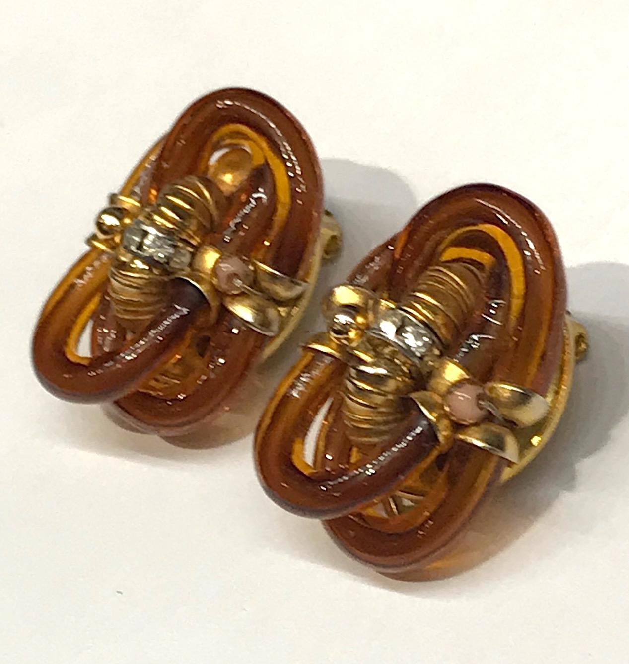 A wonderful pair of hand blown amber glass tube link earrings by famous Italian glass designer Archimede Seguso circa 1960. Each earring measures approximately .75 of an inch wide, 1 inch tall and .63 of an inch deep including the clip. The glass