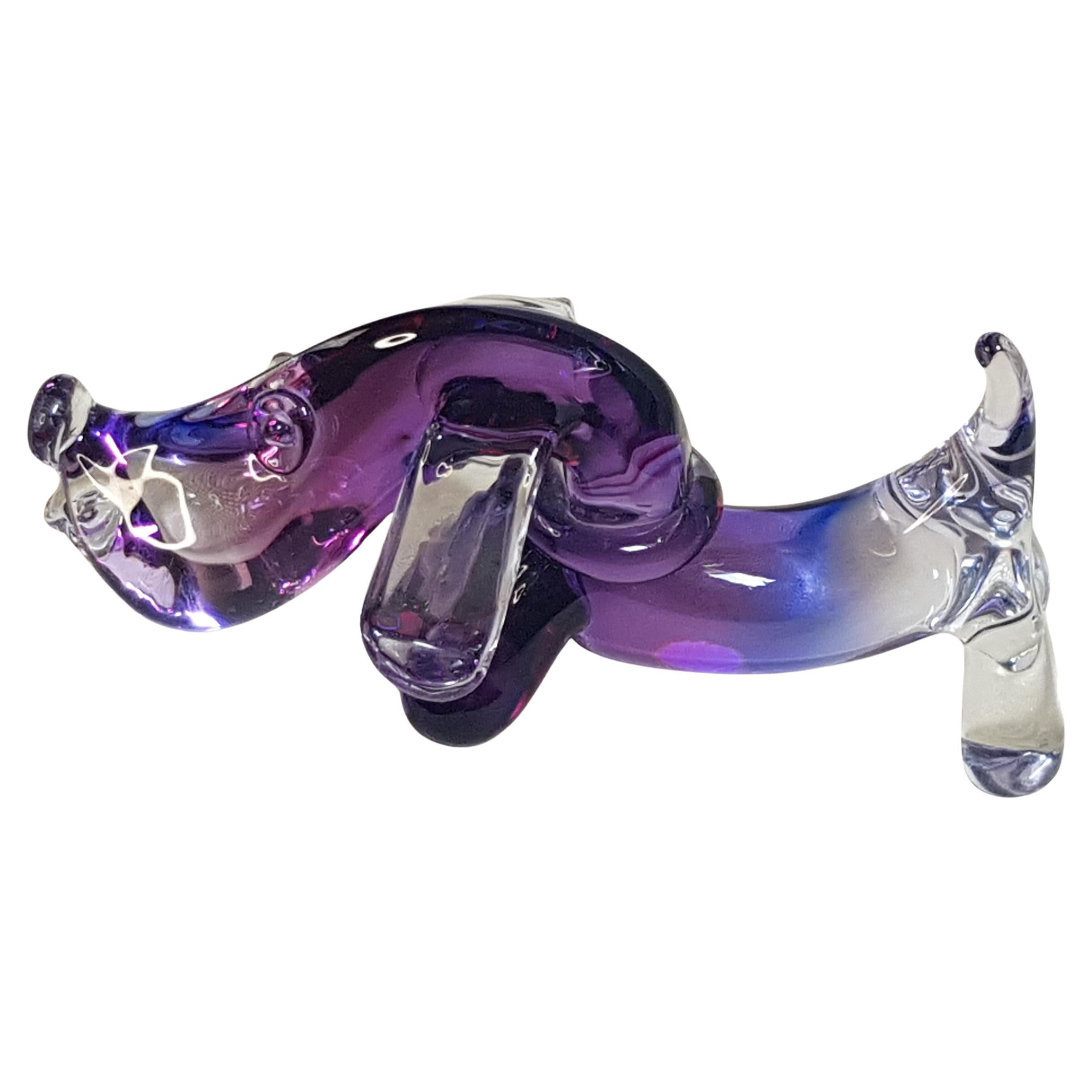 A lovely mid century murano glass sculpture by Archimede Seguso of a Dachshund Dog hand blown on the Venetian island of Murano. Crafted using sommerso violet and blue glass transitioning into clear towards the end of the dog and the tail. Archimede