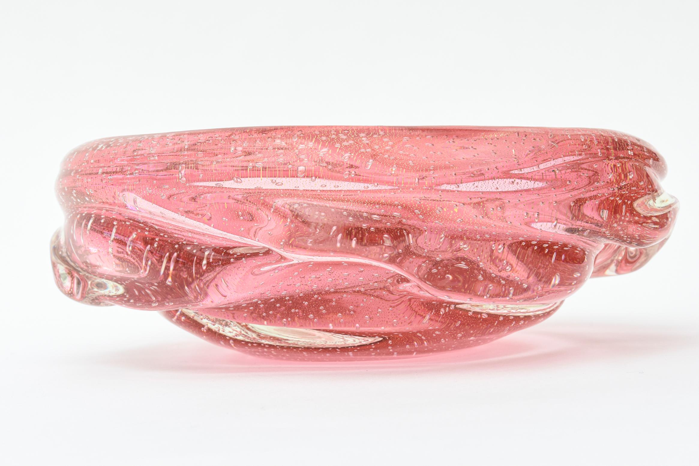 This luscious large vintage Archimede Seguso Murano cranberry to light pink glass bowl has braided glass exterior appendages with abundant Bullecante glass bubbles and interspersed gold aventurine. It is heavy and perfect as a gorgeous Murano glass