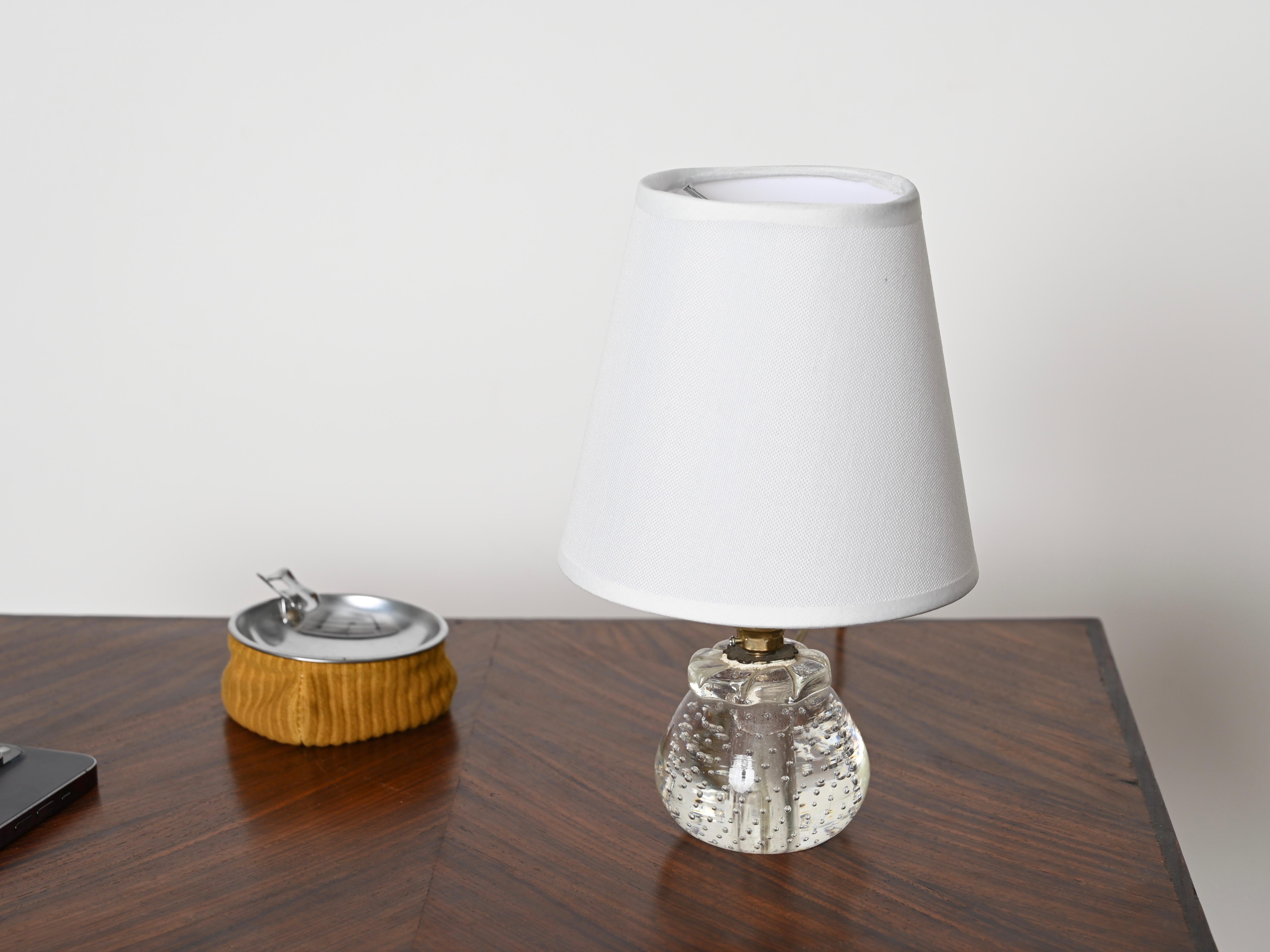 Magnificent midcentury Murano glass ball table lamp completed by an off-white fabric lampshade. This extraordinary piece was designed by a Murano master artist, Archimede Seguso, in Italy during the 1950s. 

The way the crystal Murano glass was
