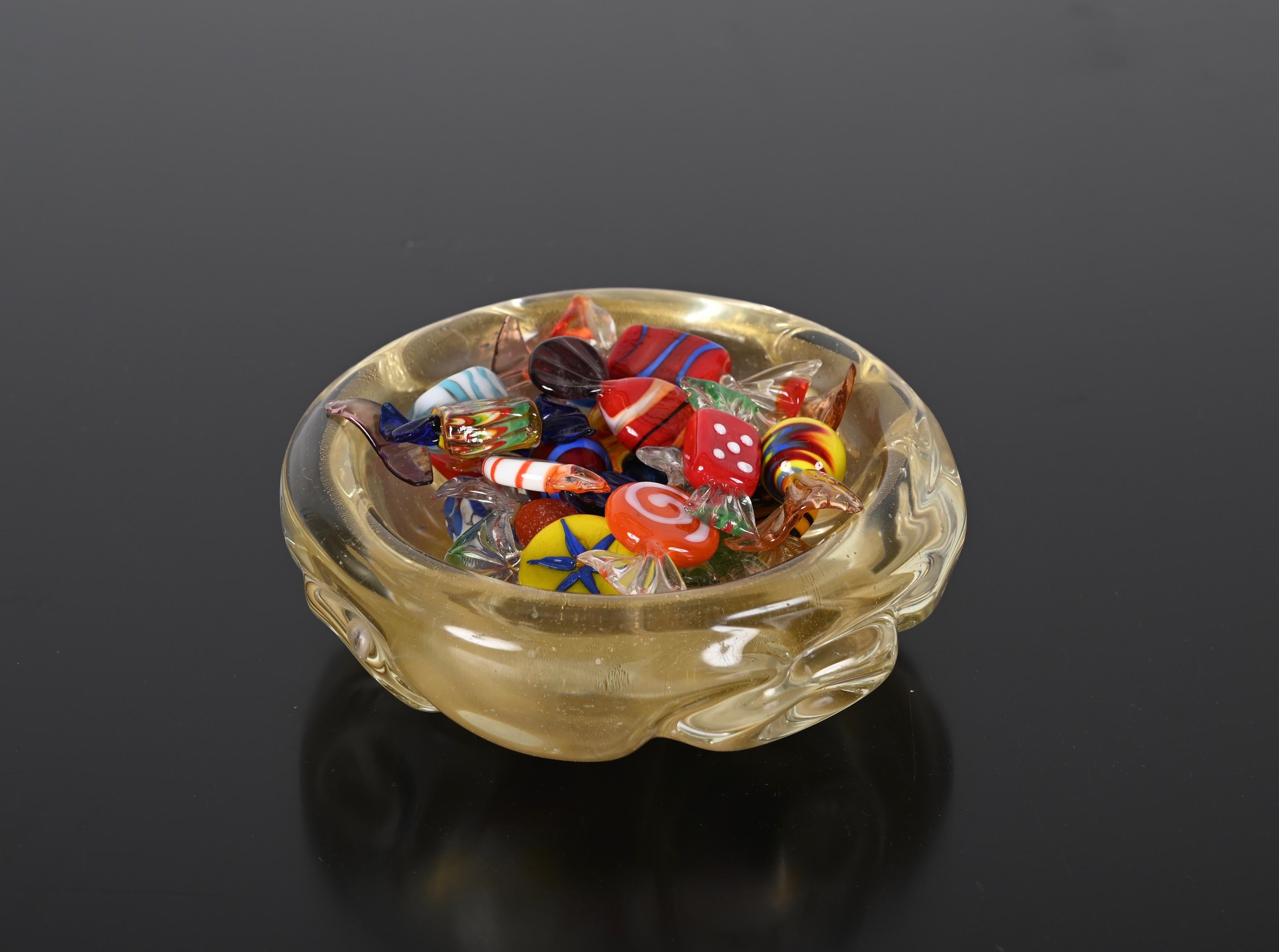Fantastic hand blown midcentury Murano glass bowl with gold dots. This fantastic object is attributed to the designer Archimede Seguso and was produced in Italy in the 1960s.

This beautiful bowl, that can be used as ashtray or pocket emptier as