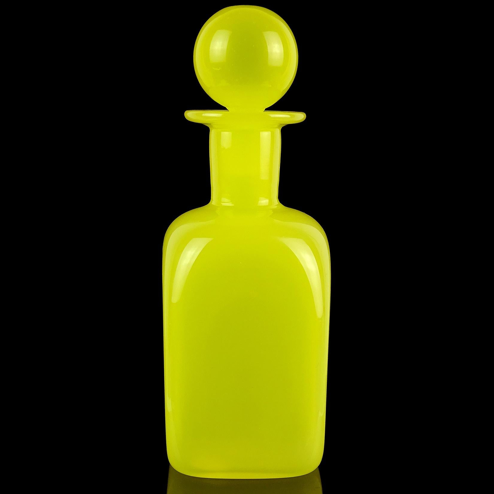 Beautiful Murano hand blown bright yellow Italian art glass decanter / bottle, with original stopper. Documented to designer Archimede Seguso. It has 2 original labels still attached, including 