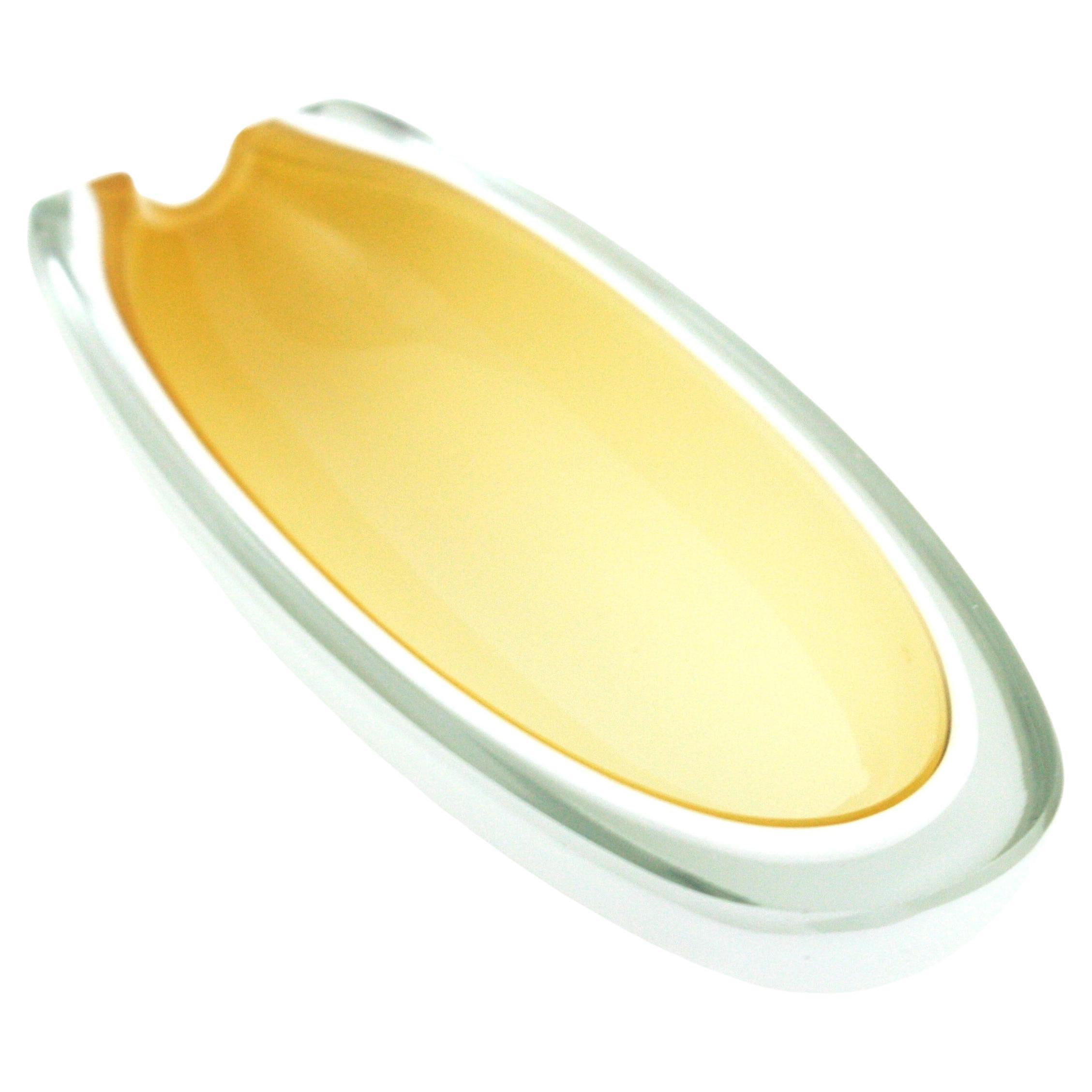 Archimede Seguso oval geode Murano glass Sommerso bowl / ashtray. Italy, 1950s-1960s.
Beautiful elongate shape with yellow and white alabastro glass cased into clear glass using the sommerso technique.
Flat cut top and flat cut side.
A layer of milk