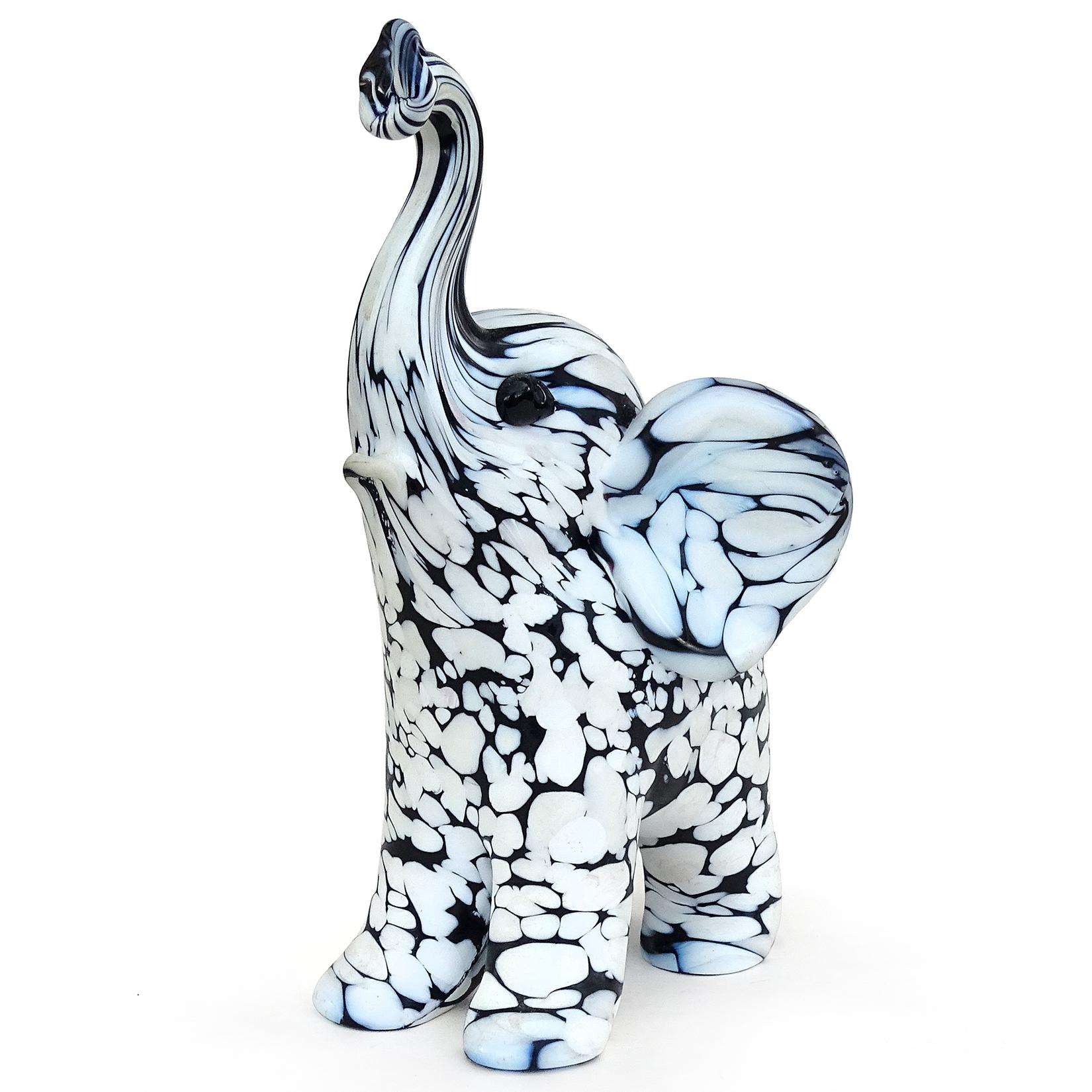 Beautiful, and rare, vintage Murano hand blown black and white spotted Italian art glass elephant sculpture. Documented to designer Archimede Seguso, from the 