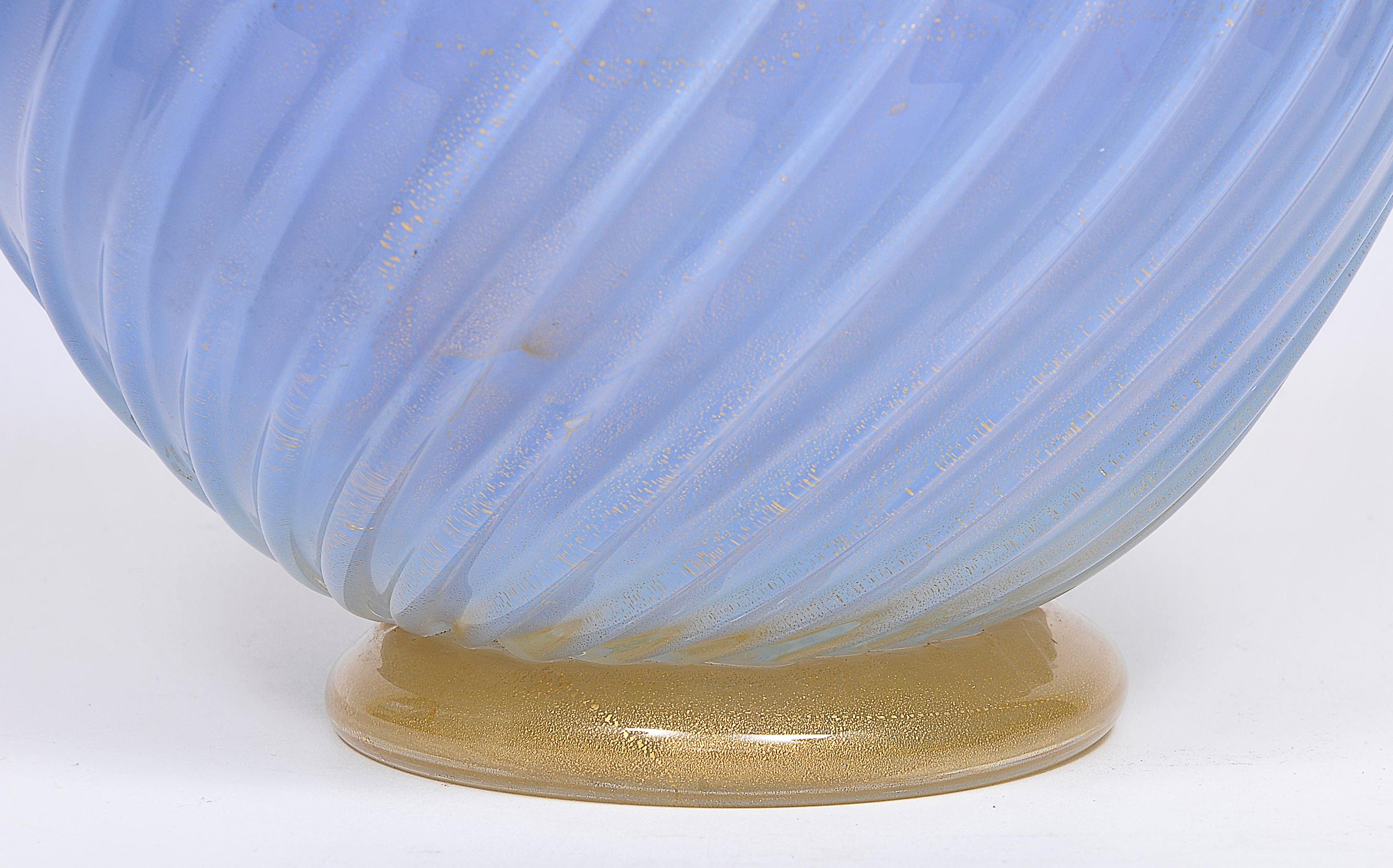 Large vase in artistic Murano glass with ribbed and twisted body in pale blue glass and collar applied in violet glass and base also applied in glass and gold, all with gold leaf.