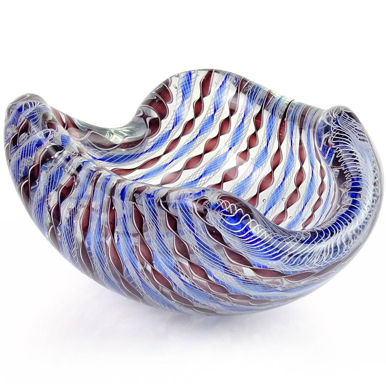 Beautiful large Murano hand blown Zanfirico twisted ribbon Italian art glass bowl. Documented to designer Archimede Seguso, circa 1955. Has blue and purple twisted ribbons, with white net over the blue. The bowl also has a biomorphic shape, creating