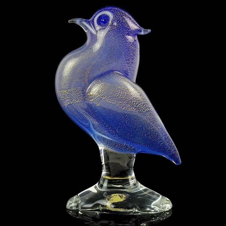 Beautiful Murano hand blown cobalt blue and gold flecks Italian art glass bird on clear pedestal sculpture. Documented to designer Archimede Seguso. It stills retains a worn 