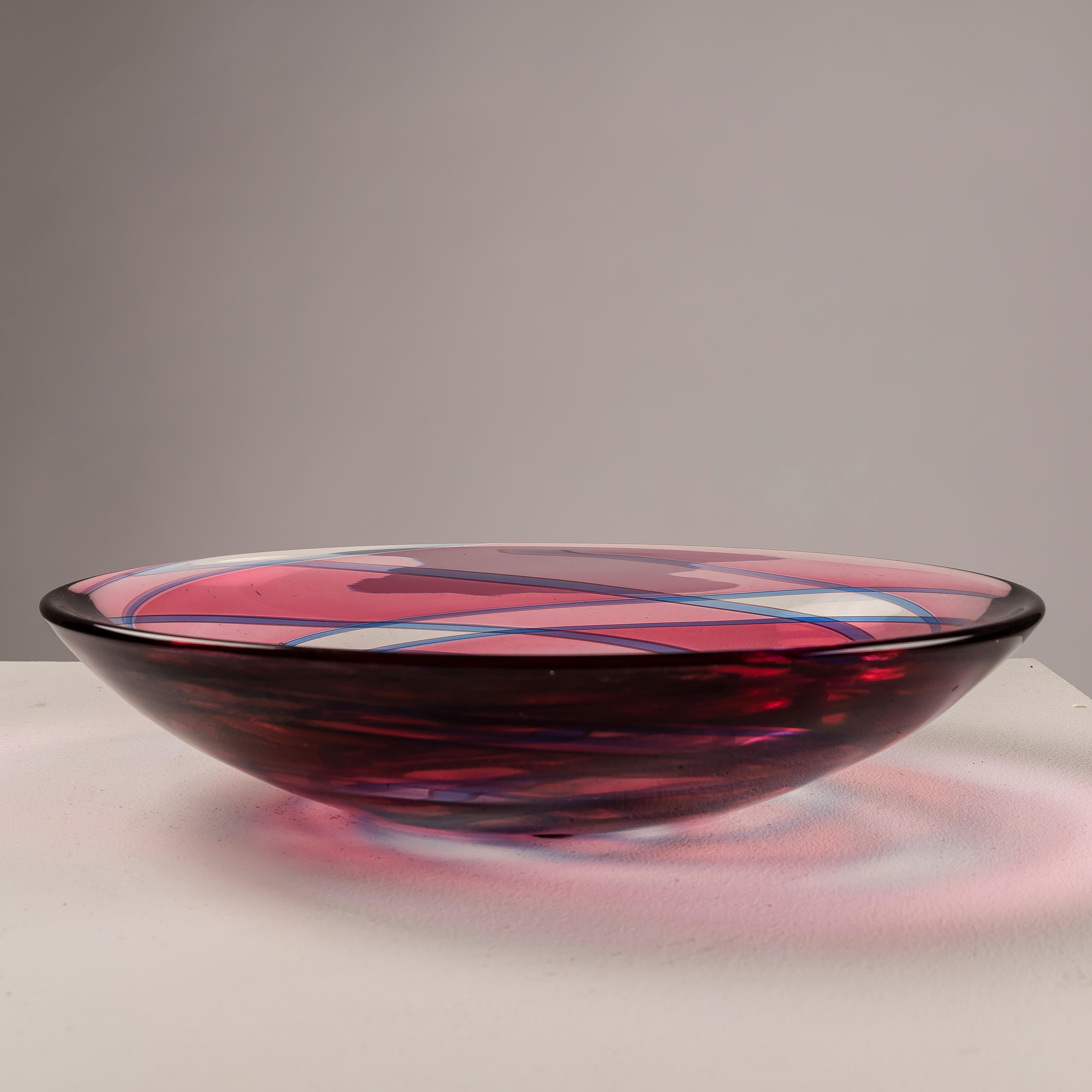 Immerse yourself in the mesmerizing beauty of Murano glass artistry with the geometric pink and blue glass bowl crafted by Archimede Seguso in the 1960s. This exquisite piece epitomizes the unparalleled craftsmanship and artistic innovation for