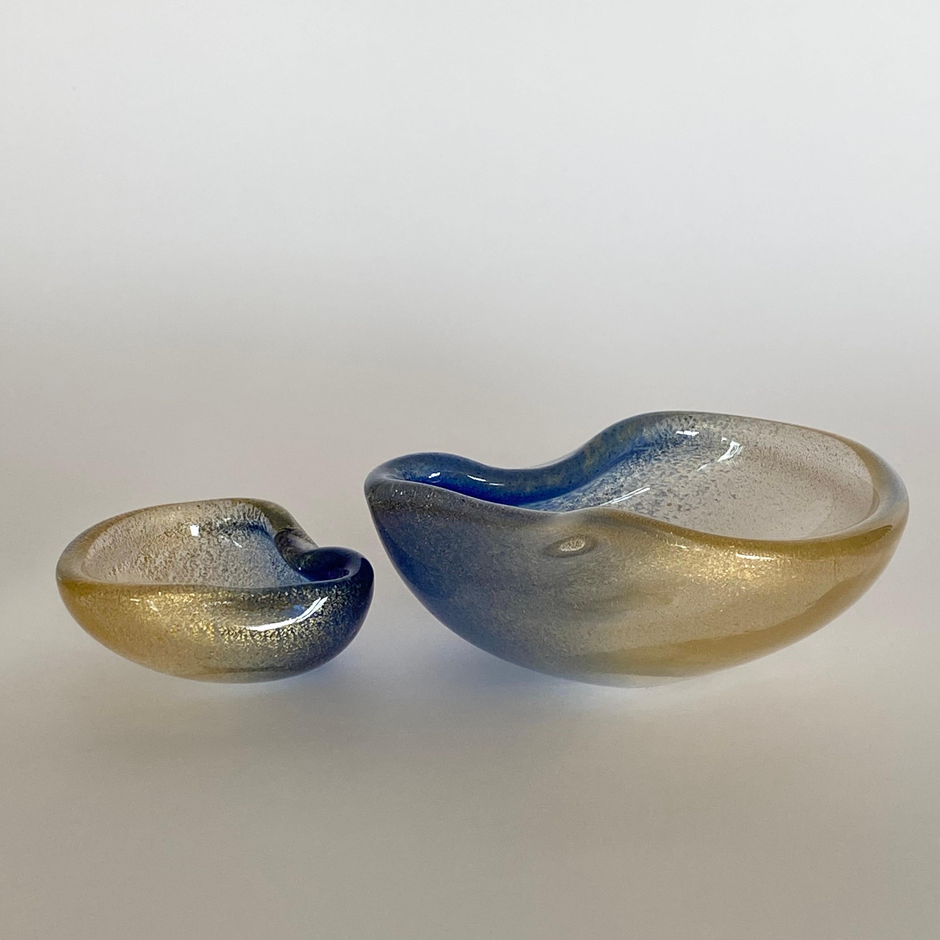 Set of 2 gold infused Murano Glass Nesting Bowls by Archimede Seguso. Handblown and colored with indigo blue color pigments which is a unique technique developed by Archimede Seguso. 
Due to its complexity, this style was manufactured for a brief