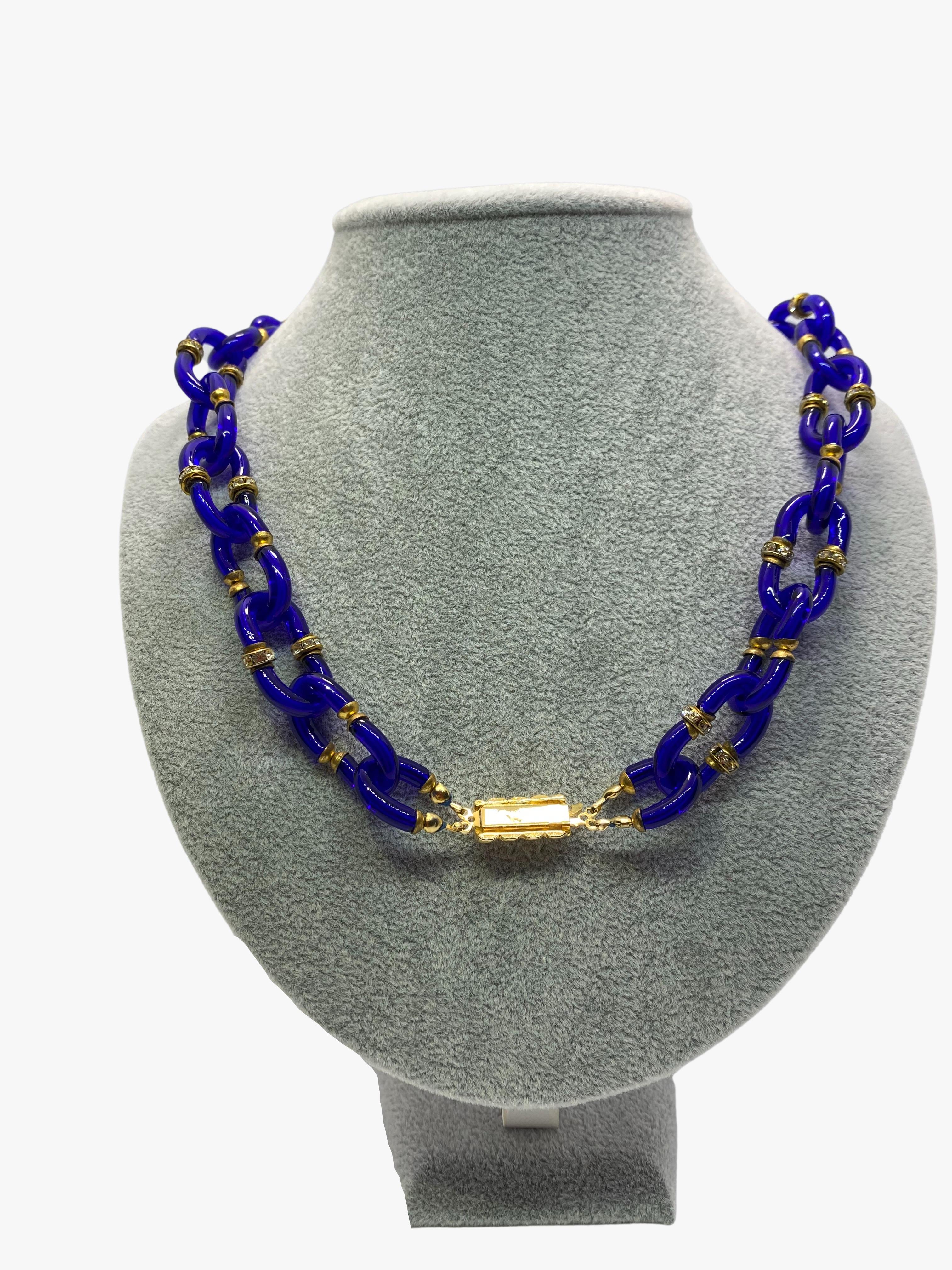 Vintage necklace designed by Archimede Seguso in collaboration with Coco Chanel. The glass “C” shape links create an interlocking Chanel CC logo.

The chain made from Murano glass in dark blue color. Chain links are fastened with brass and randomly