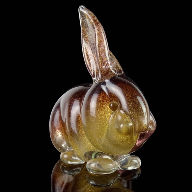 Beautiful and very cute set of Murano hand blown dark brown and gold flecks Italian art glass bunny rabbit sculptures or figurines. Documented to designer Archimede Seguso, in the “Pulveri” technique. One still retains the original 