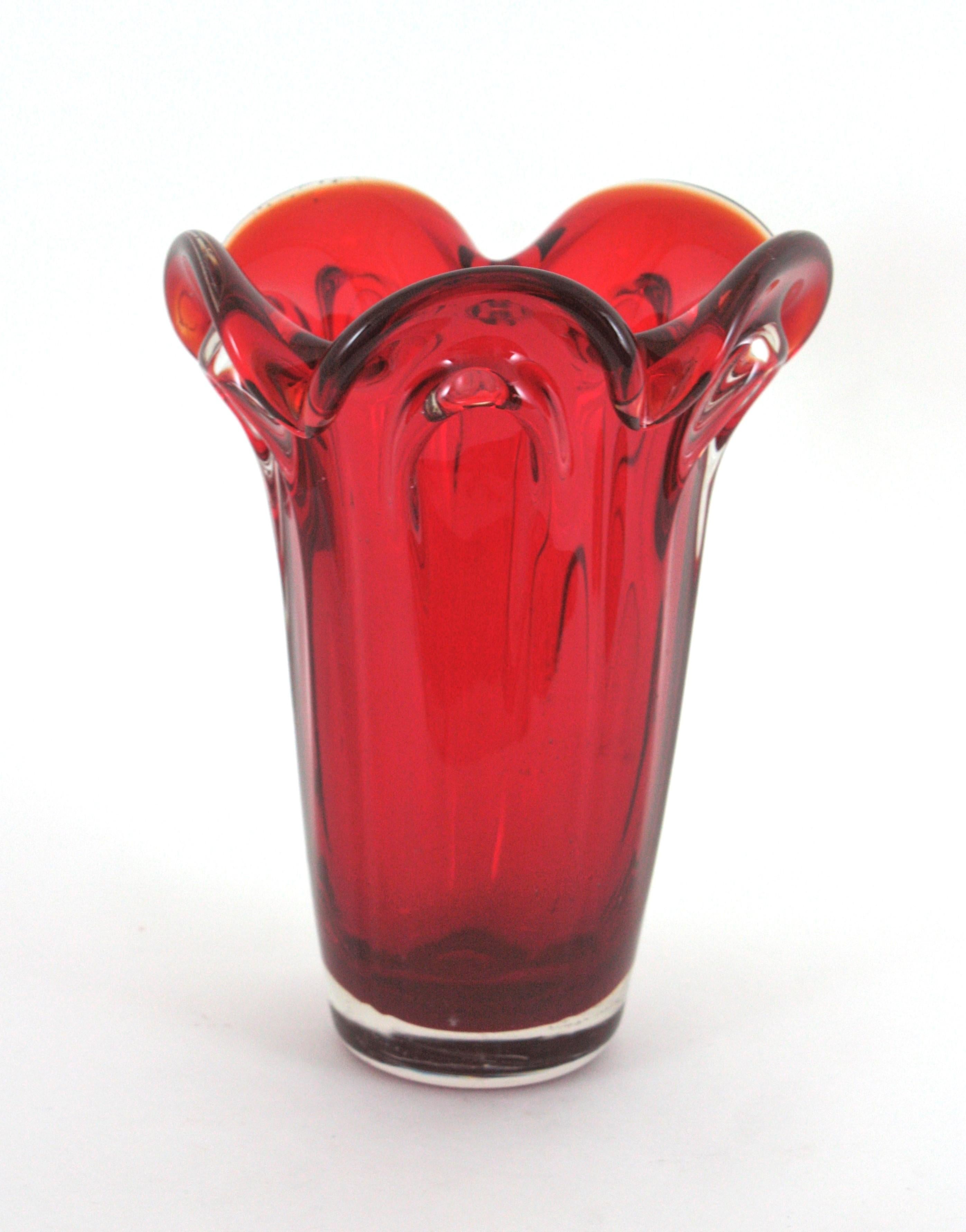Mid-Century Modern Murano Blown Glass Red Vase
Large Size.
An spectacular handblown Murano art glass vase in a vibrant ruby red color and tall flower shape. Attributed to Archimede Seguso. Very attractive when light goes down on it.
Excellent