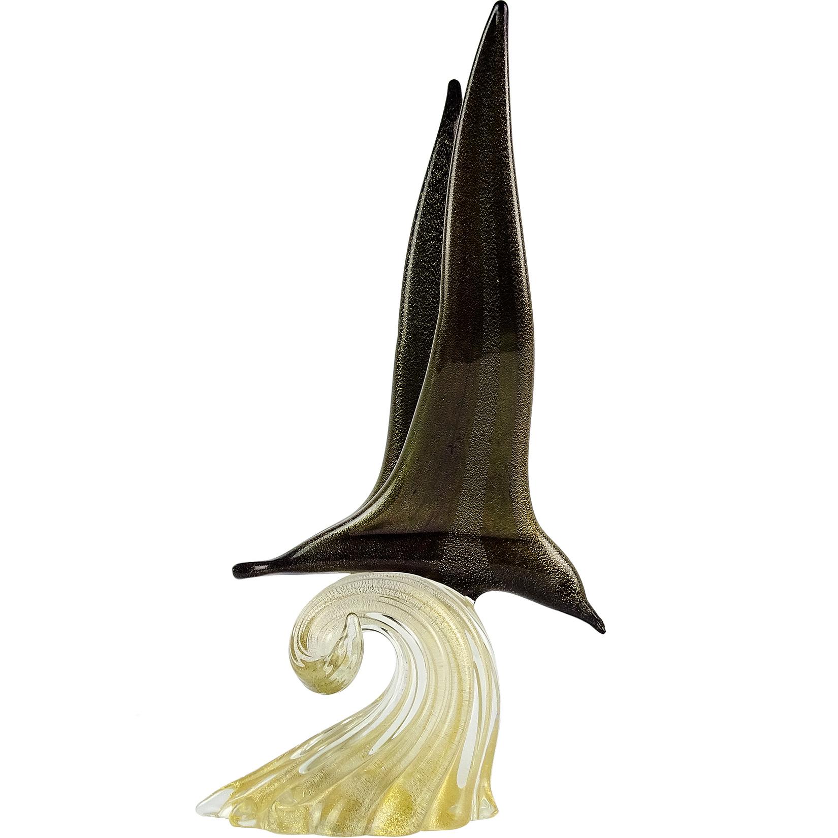 Beautiful vintage Murano hand blown black and gold flecks Italian art glass flying seagull over water sculpture. Signed underneath, Archimede Seguso Murano, circa 1960-1970. The bird stands on a wave of glass filled with gold leaf. The signature was