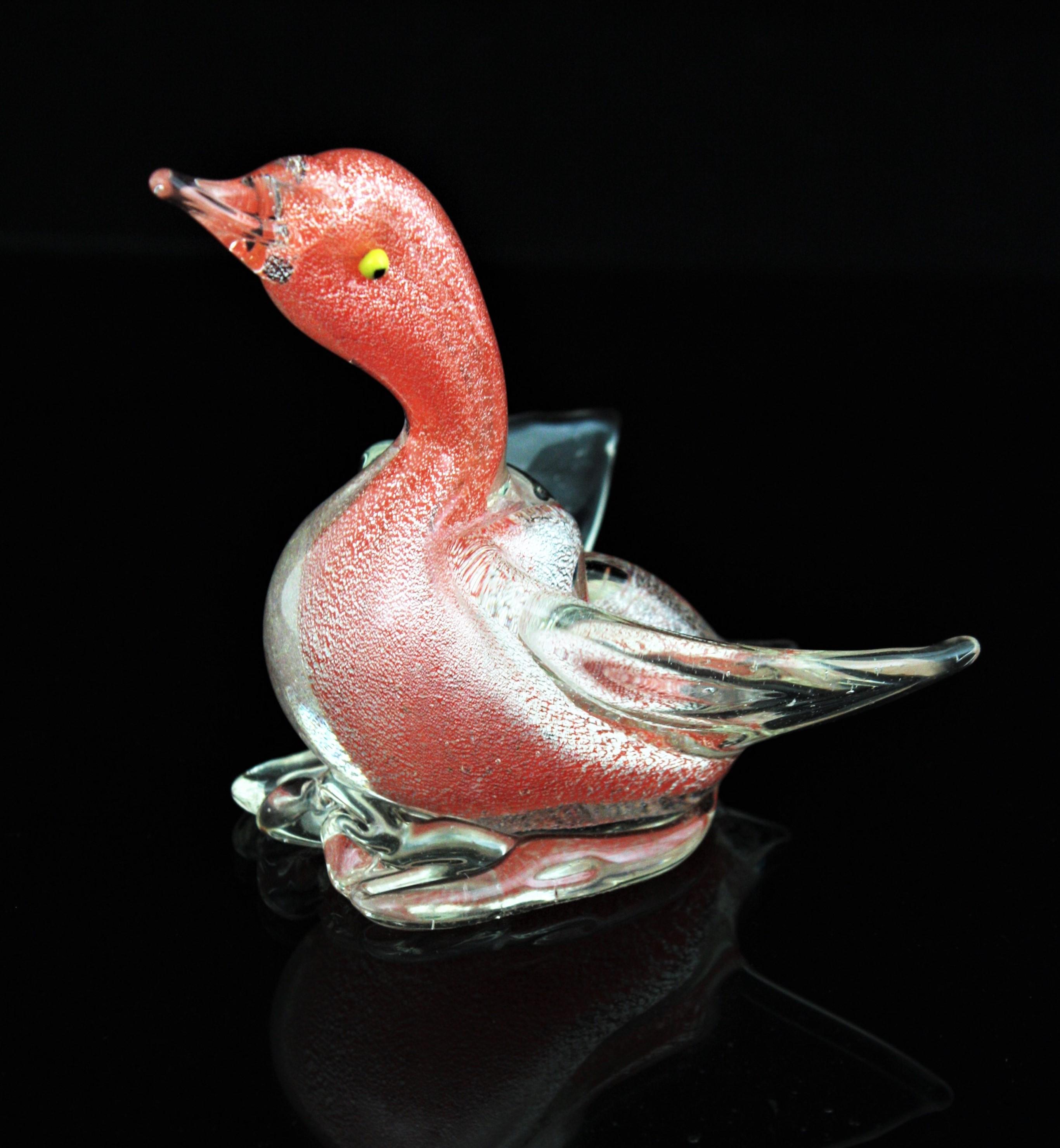 Small hand blown Murano glass open wings duck / bird figurine with silver flecks. Attributed to Archimede Seguso, Italy 1950s.
Cute open wings standing up duck figure. Vibrant orange glass submerged into clear glass accented by silver Aventurine