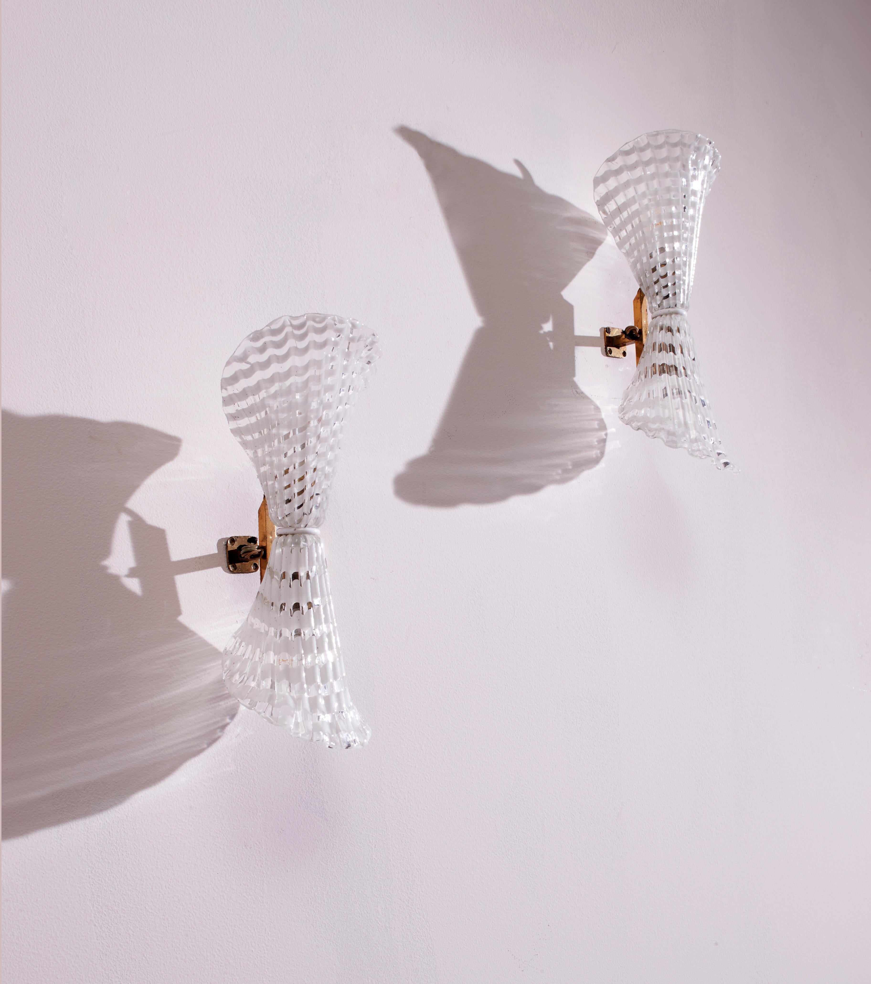 A pair of elegant Murano lattimo glass wall sconces, designed by Archimede Seguso, once adorned the interiors of the Hotel Bristol in Merano back in 1954.

These captivating wall sconces, born from the creative genius of Archimede Seguso,