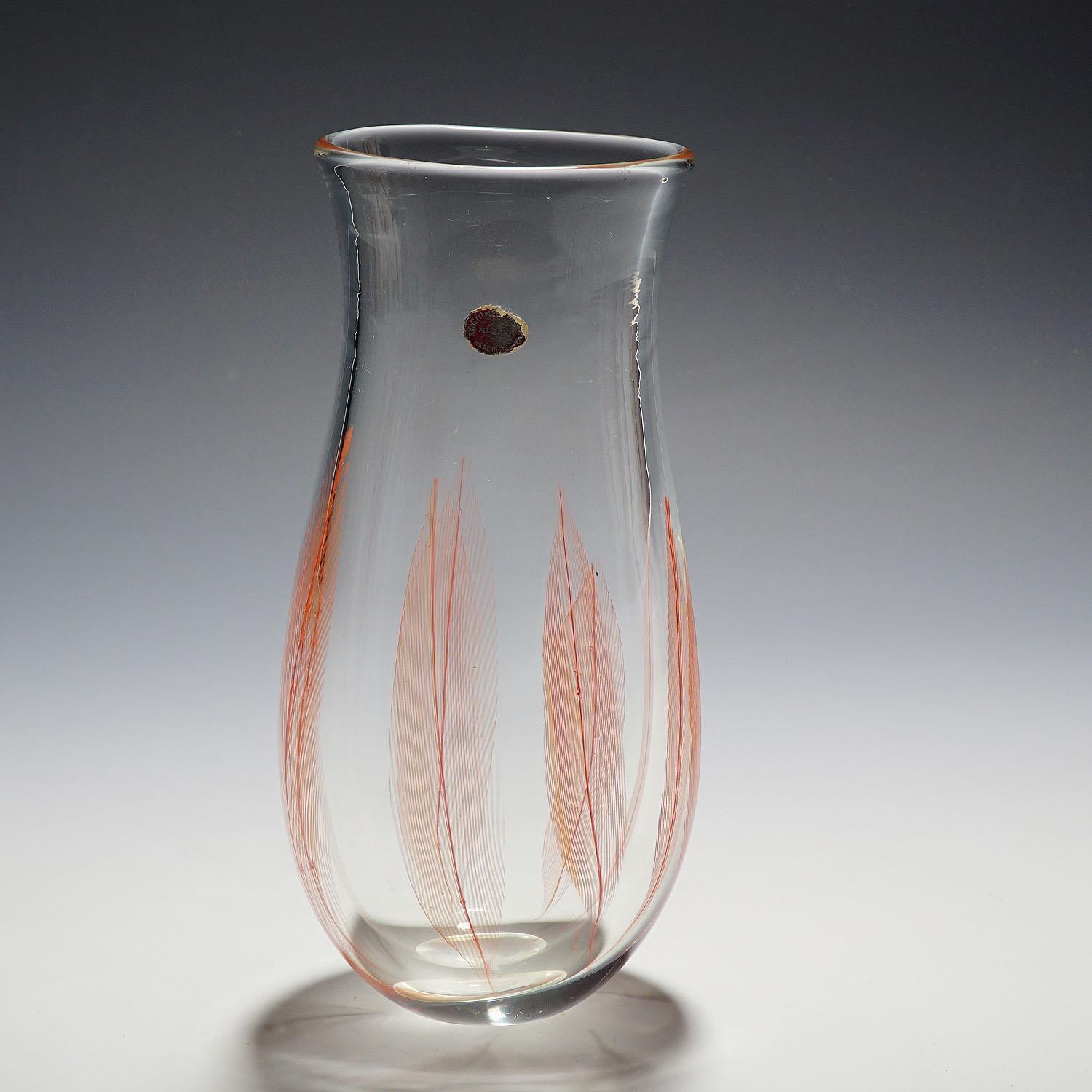 A Venetian art glass vase of the 'Piume' (feather) series. Designed by Archimede Seguso for Vetreria Artistica Archimede Seguso ca. 1956. Thick clear glass internally decorated with coral red glass feathers. A famous design of Murano's Master of the