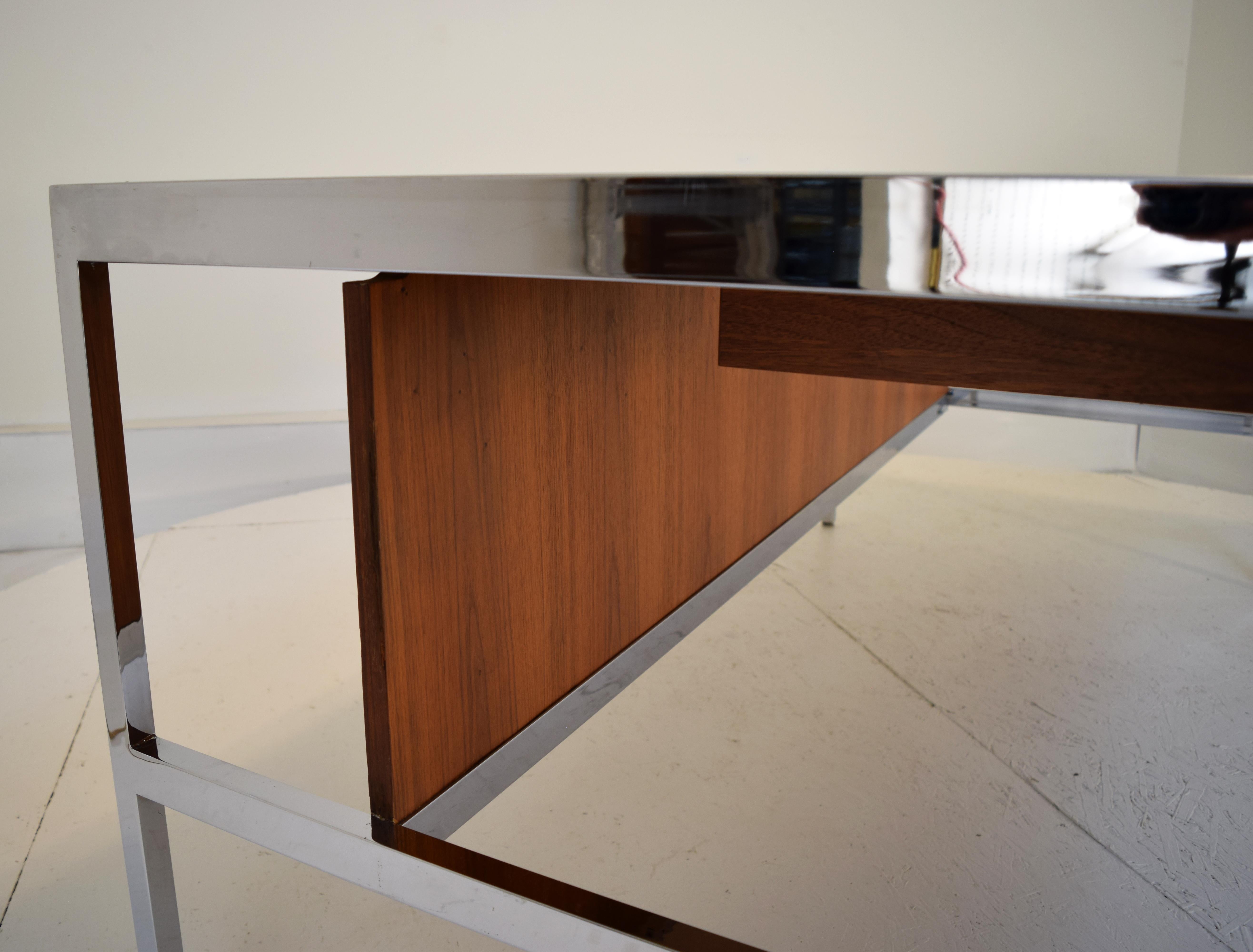 A beautiful modernist desk attributed to Gordon Bunshaft. It is unmarked however the design and construction strongly suggests it is his work with a minimalist approach. Produced circa 1970. A beautiful desk with rich walnut and solid steel frames
