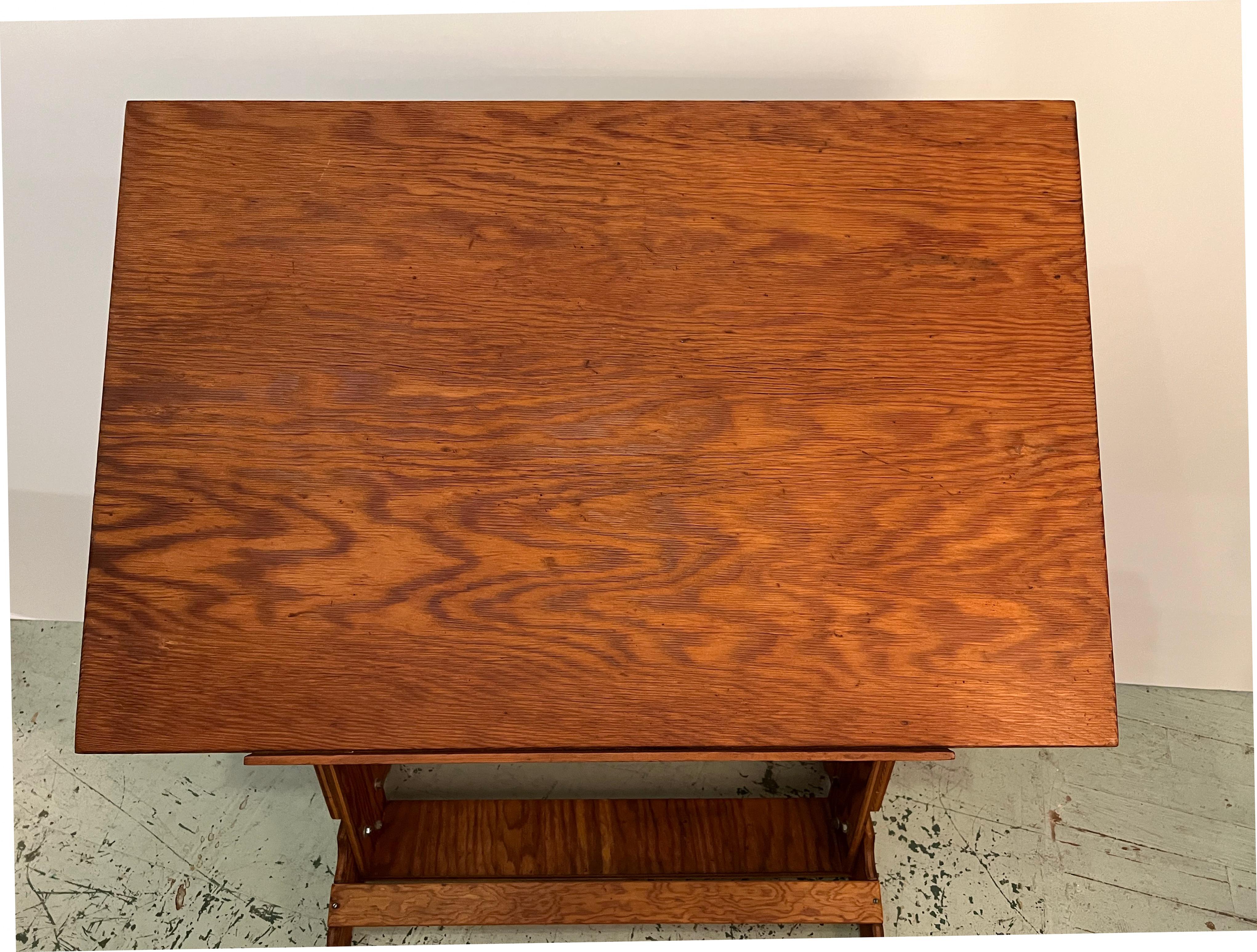 Vintage French architect’s or drafting table with an adjustable drawing surface which may be set at a variety of angles and heights. It can be adjusted from 41' inches up to 50' inches in height.
It is made of red pine.