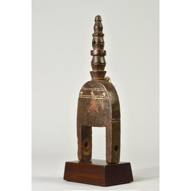 Architectonic Kulango Pulley with a Tall Finial in Wood

This piece was acquired by Thomas McNemar, who lived outside of Abidjan in the late 1950s and early 1960s. He toured the country collecting, among other things, hundreds of pulleys. Figurative