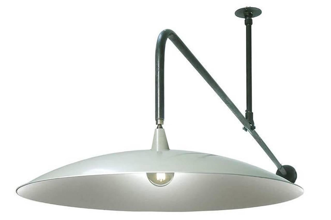 Dramatic is an understatement for this early Architects studio lamp. The hand spun shallow profile shade is over 36 inches in diameter and was designed to reflect a pleasing even light over a drafting table. It still has its original satin putty