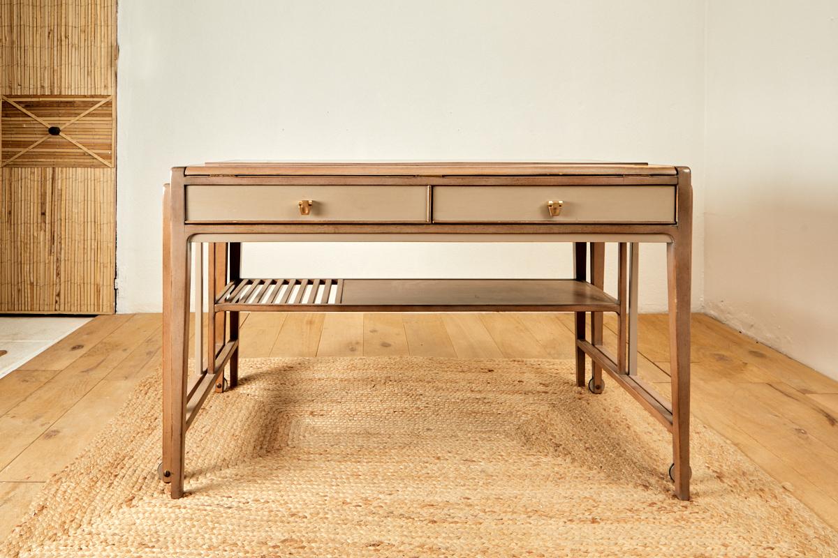 Architect's desk in sliding beige lacquered wood with metal-plated casters,
hinged top,  two belt drawers, circa 1970, France.
Height 76 cm, width 11! cm, open 2m27, depth 69 cm.