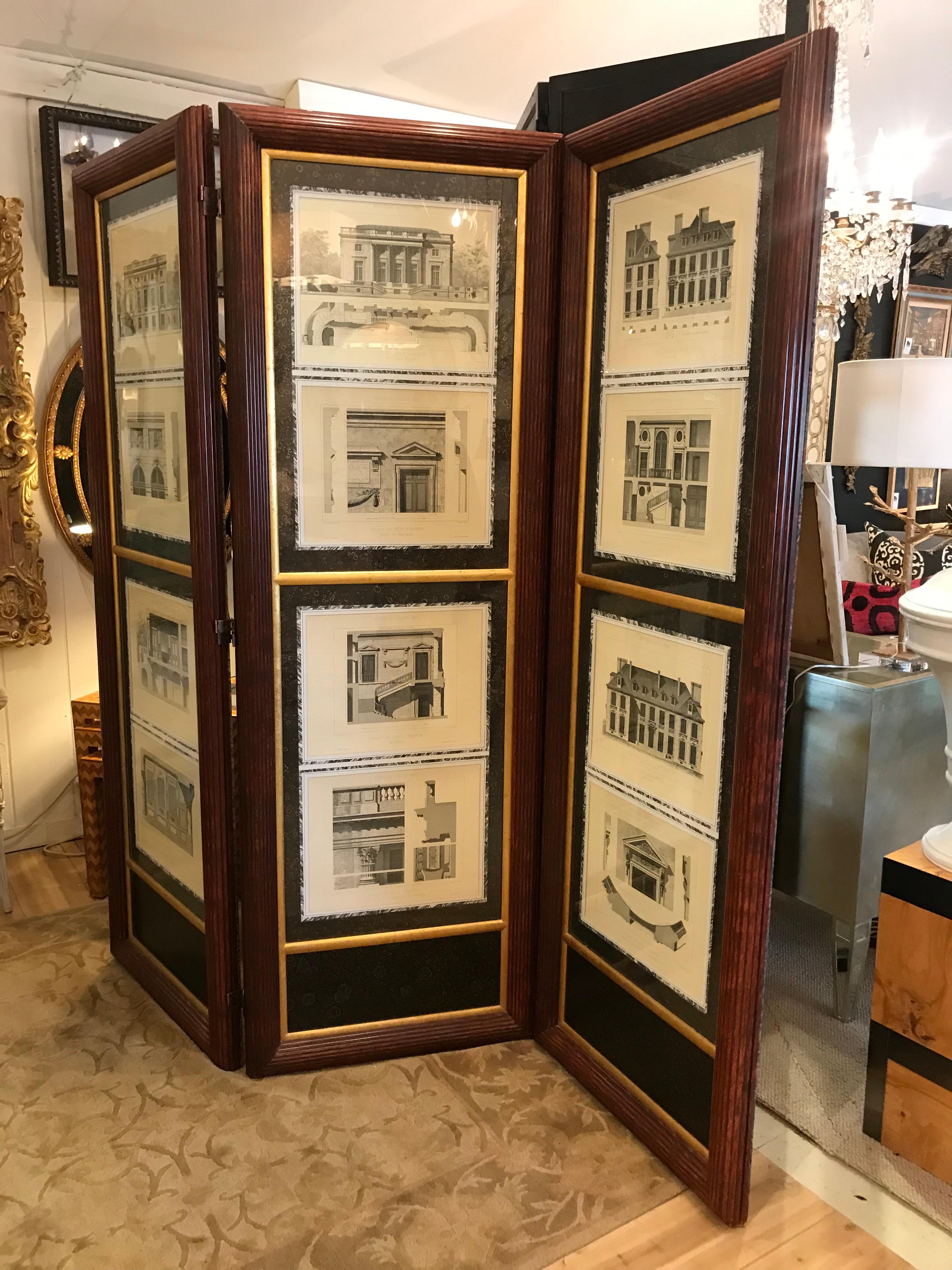Stately screen or room divider in mahogany and glass that showcases architectural renderings of French buildings. The drawings have Italian paper surrounds and gilt moldings. The mahogany framing is fluted. The reverse side of screen is a dark