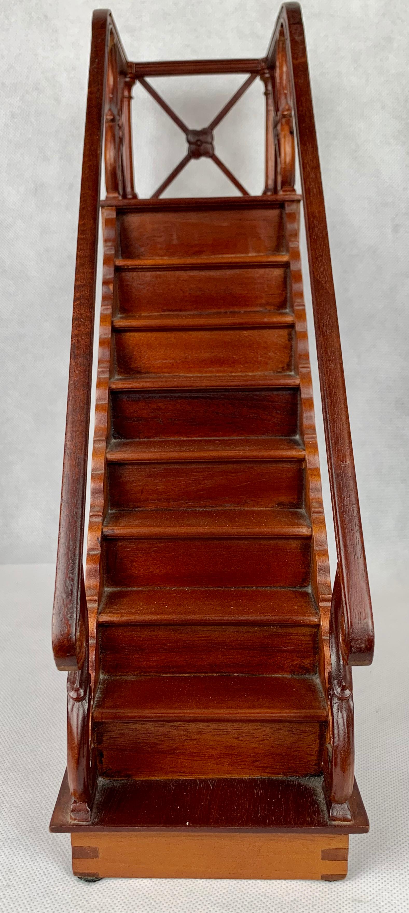 Vintage architect's model staircase in mahogany. The model has nine steps and double railings terminating with a landing. The base is dovetailed.
This model is also very useful for displaying a collection of small items.