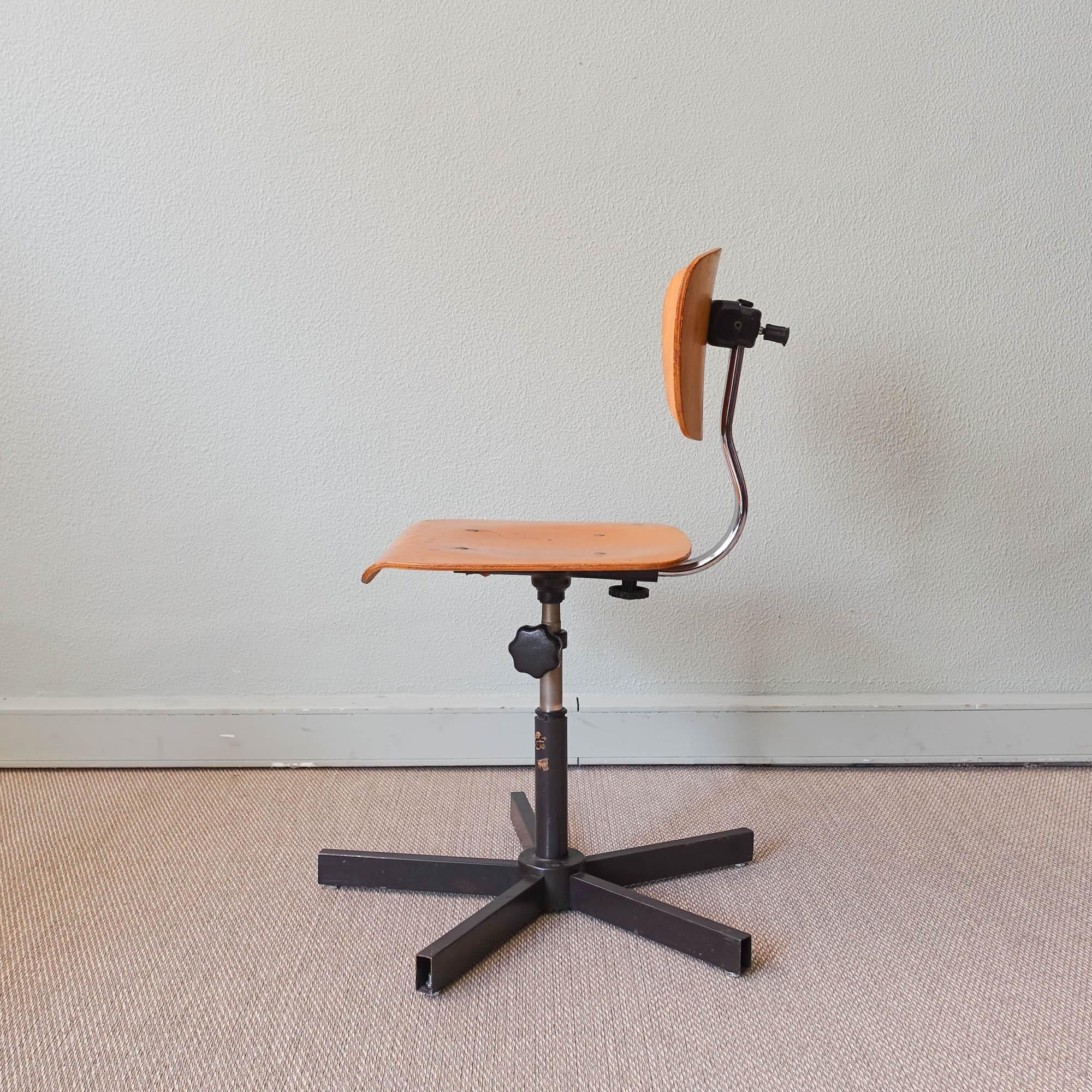 This vintage architect's swivel chair was designed and produced by Bima in Germany, in 1989. This work chair has a beech wood backrest and seat that is adjustable in height for different seating positions. Marked underneath with the company's name,