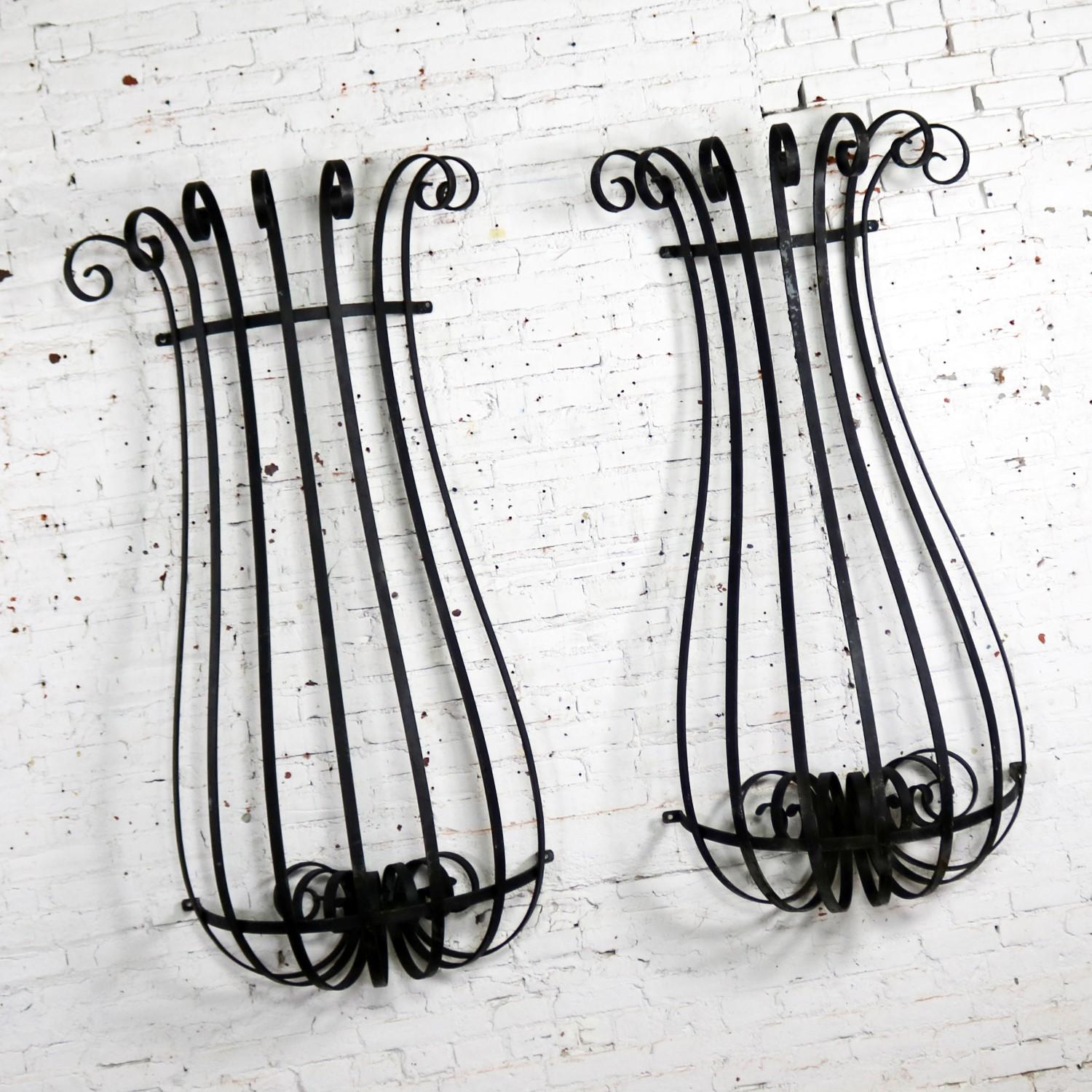 Fabulous architectural antique hand-wrought iron window guards. Or, they could/can be wall urn planters window boxes. They are in wonderful antique condition with nice age patina. Priced for the pair, circa 1920s-1970s.

Wow! These architectural