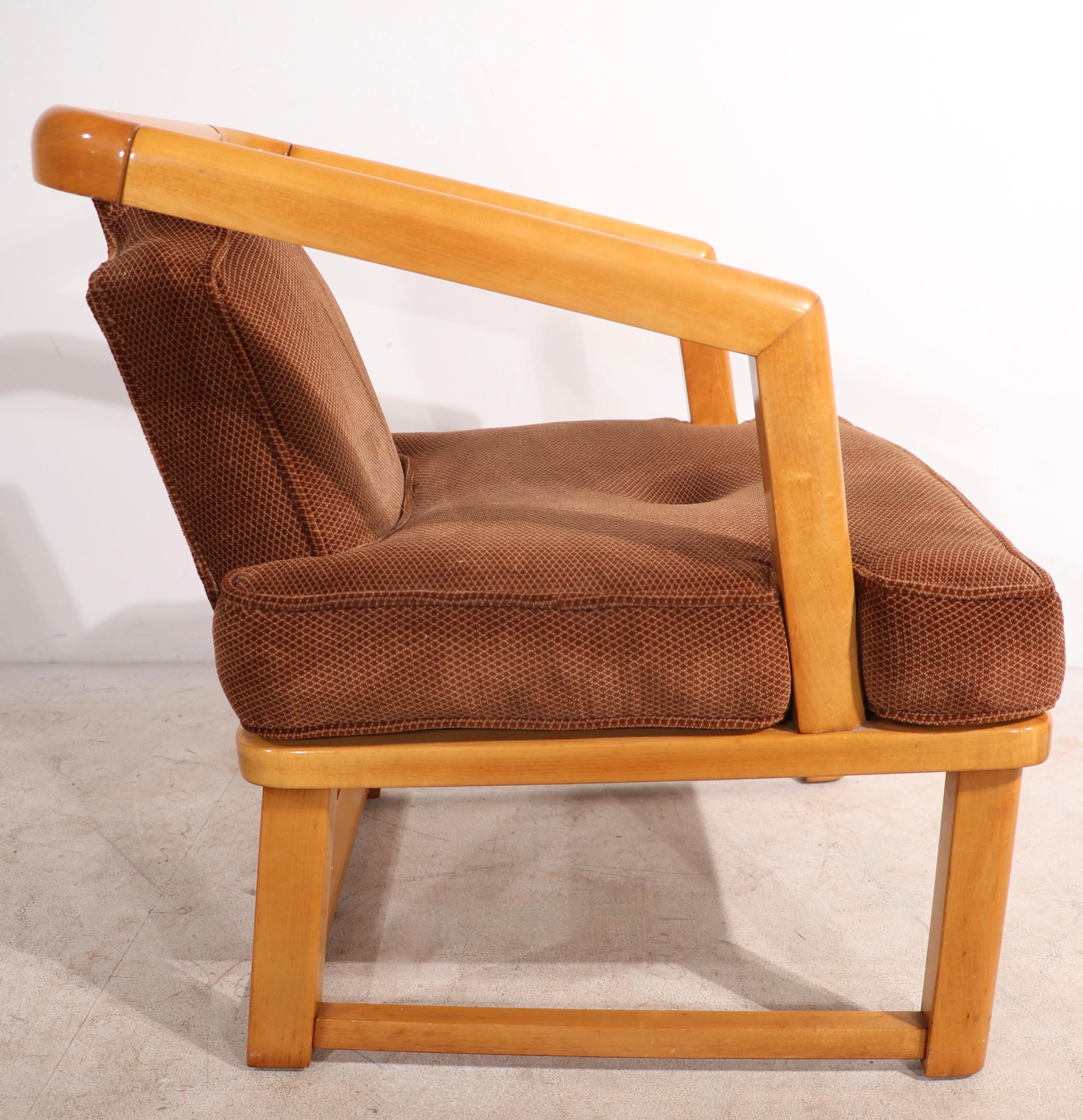 Chic architectural arm chair having a solid wood ( maple ) frame with upholstered seat and back. The chair is in very good, original condition, clean and ready to use. We cannot document the form, however we believe the chair is an example of the