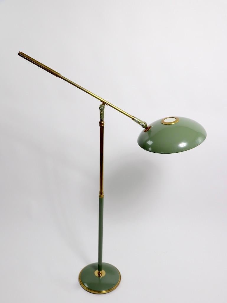 Classic floor, reading lamp, designed by Gerald Thurston, for Lightolier. The lamp has several adjustments, including height, and angle of disk shade. The disk shade can be rotated on the arm (side to side) and tilts (up/ down) as well. The center