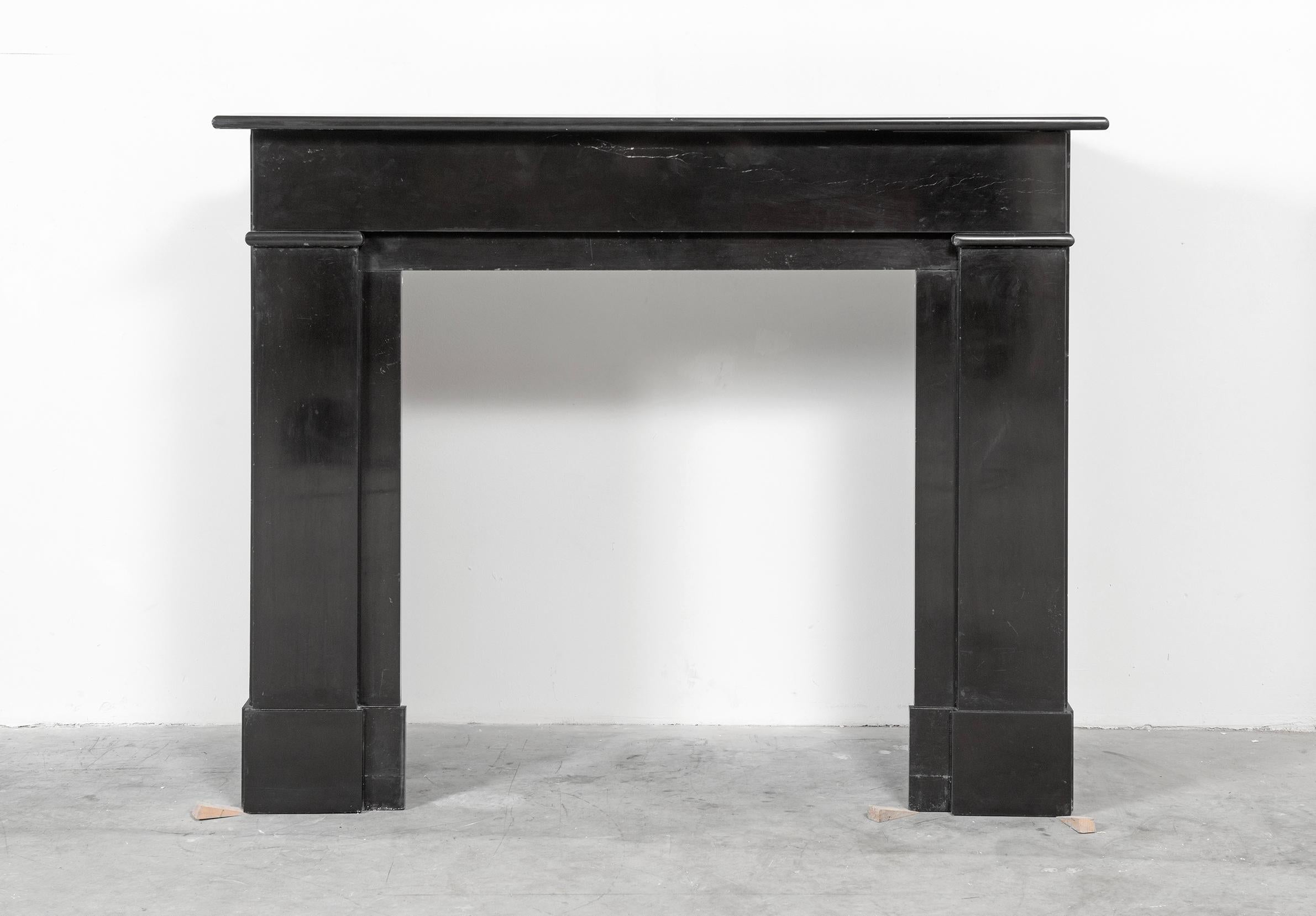 A nice Dutch paneled fireplace in Belgian black marble.
This deep black marble come from the quarry of Mazy.
Made between 1920 and 1970 these mantels where used all over Holland, usually in multi story houses with on each floor two similar