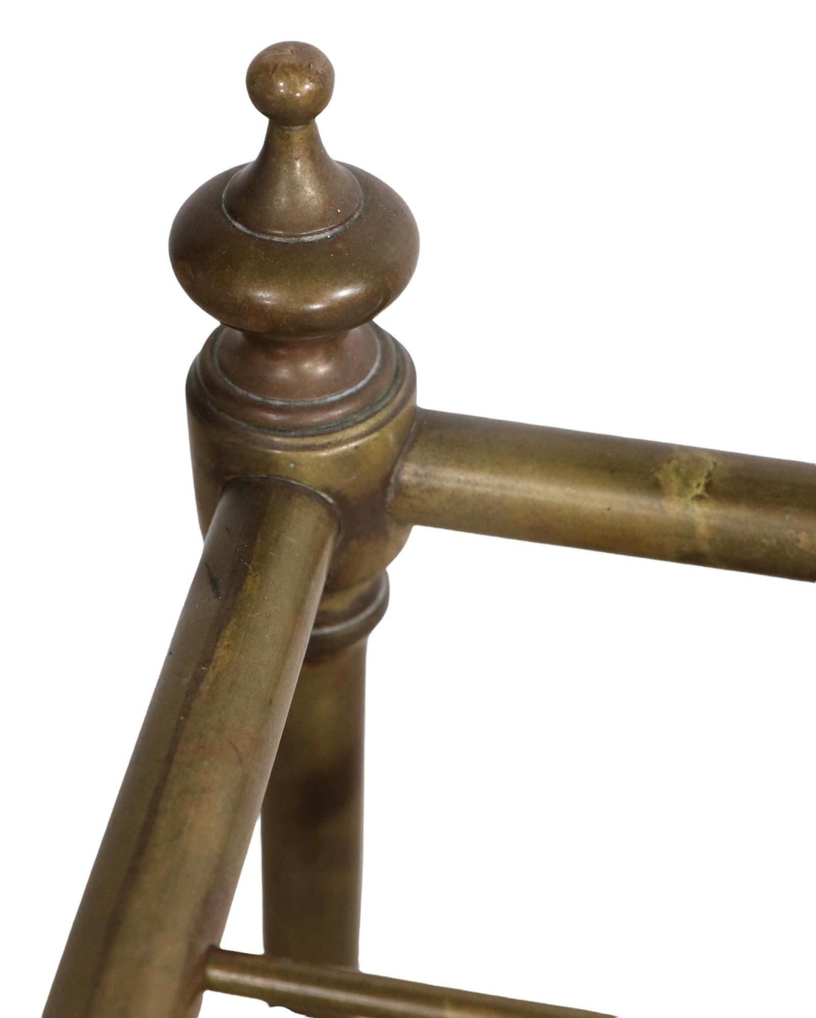Well constructed, well designed and tasteful umbrella, cane holder rack, stand in brass and iron. This piece is solid, sturdy, clean, and ready to use, showing only light cosmetic wear, normal and consistent with age. Probably made in France, or